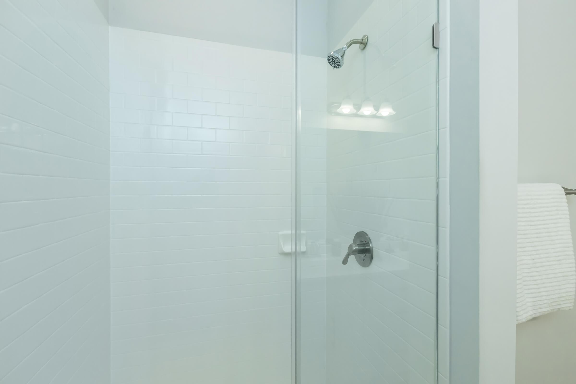 ELEGANT GLASS PANEL SHOWER WITH SUBWAY TILE