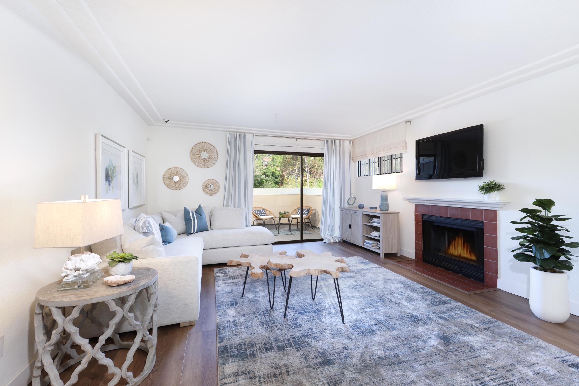 a living room filled with furniture and a fireplace