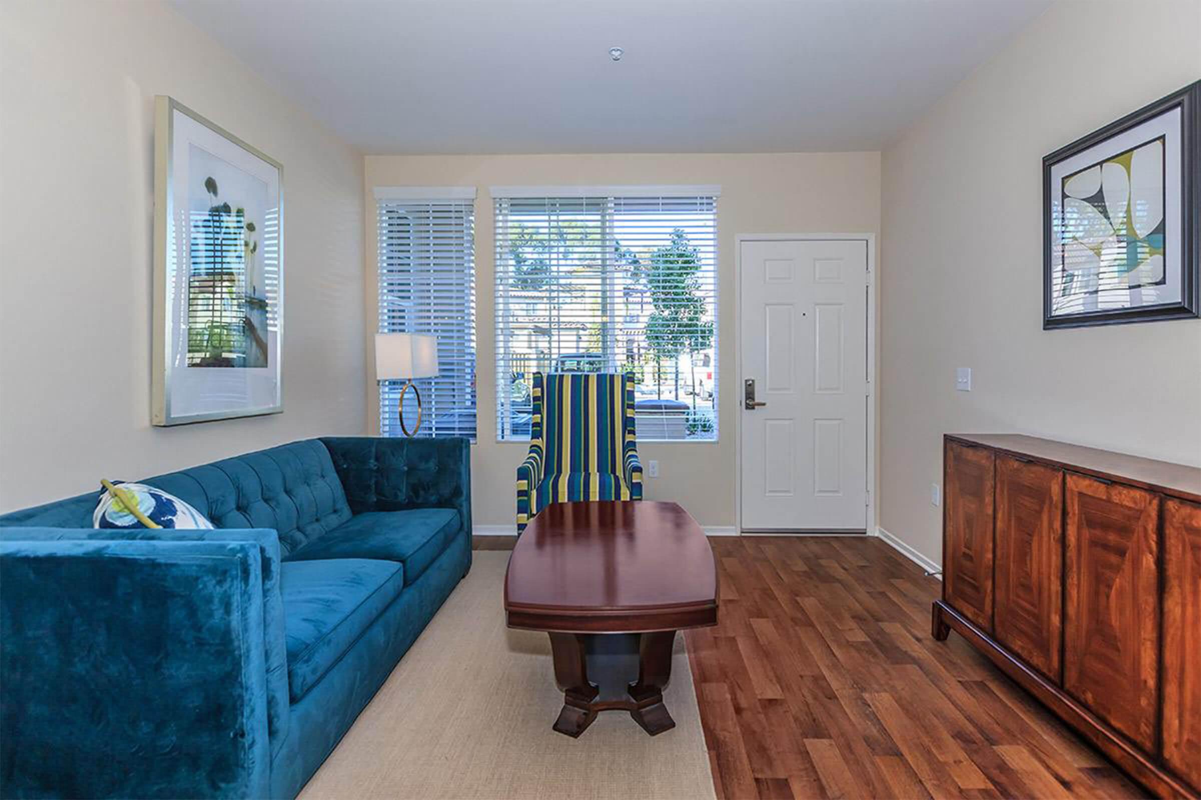 a living room filled with furniture and a large window