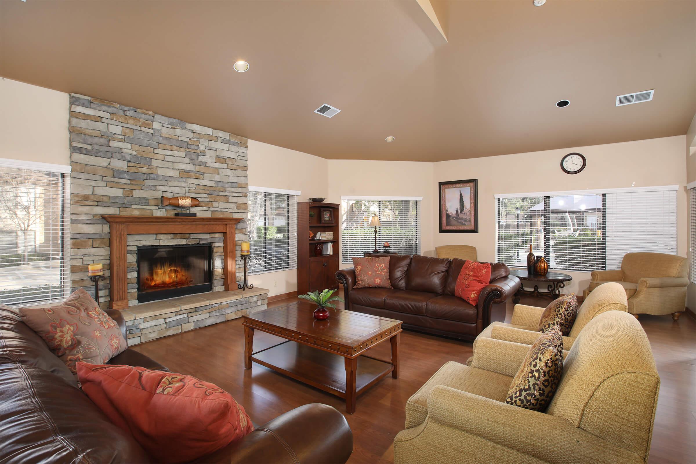 a living room filled with furniture and a fire place