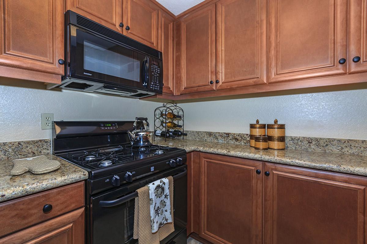 a kitchen with stainless steel appliances and wooden cabinets