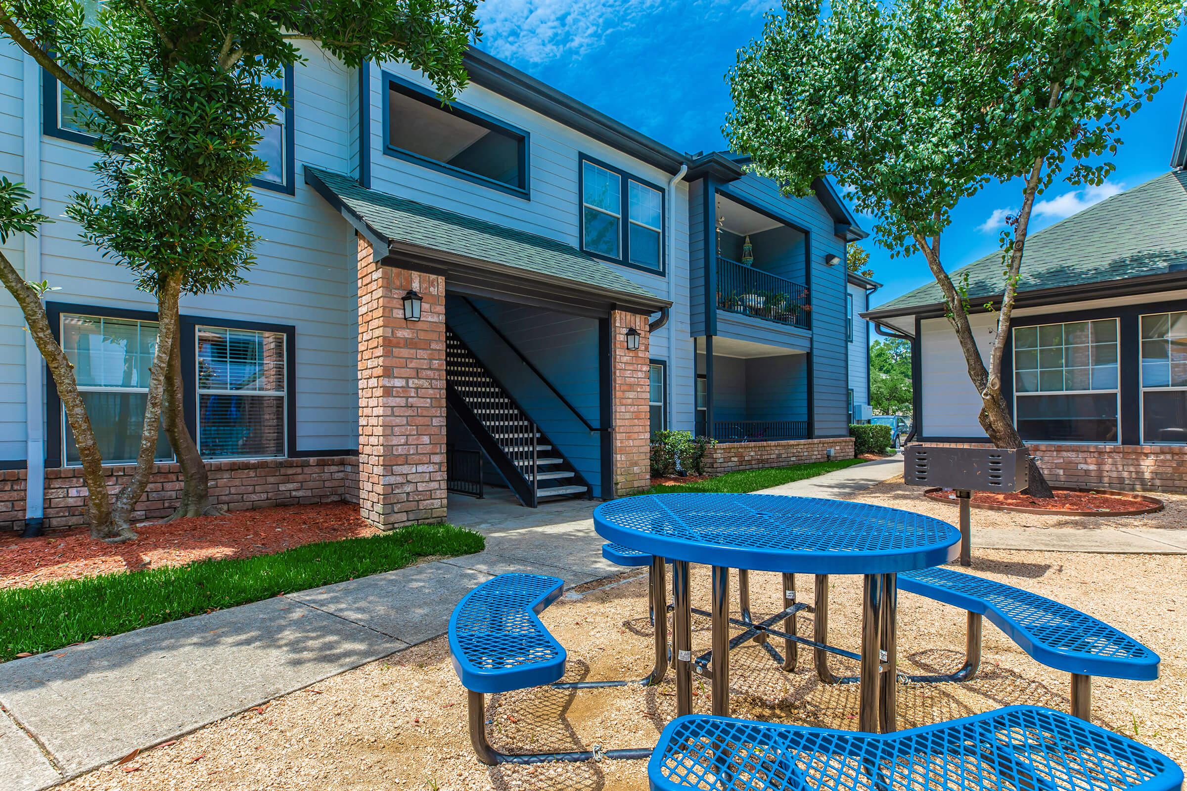 a blue bench in front of a house