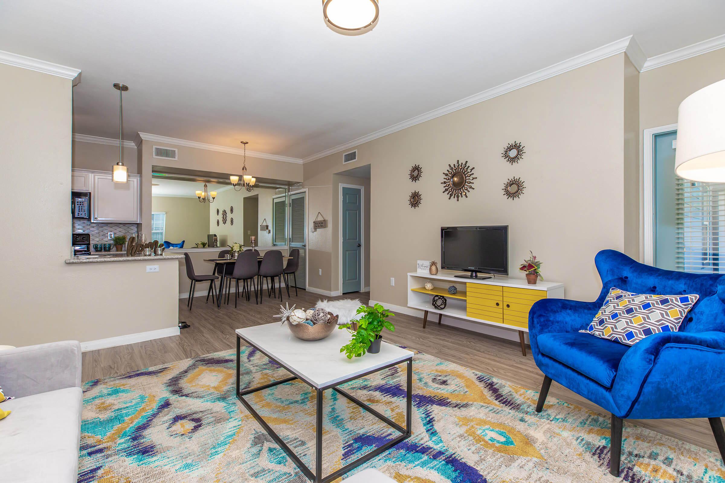 a living room filled with furniture and a large window