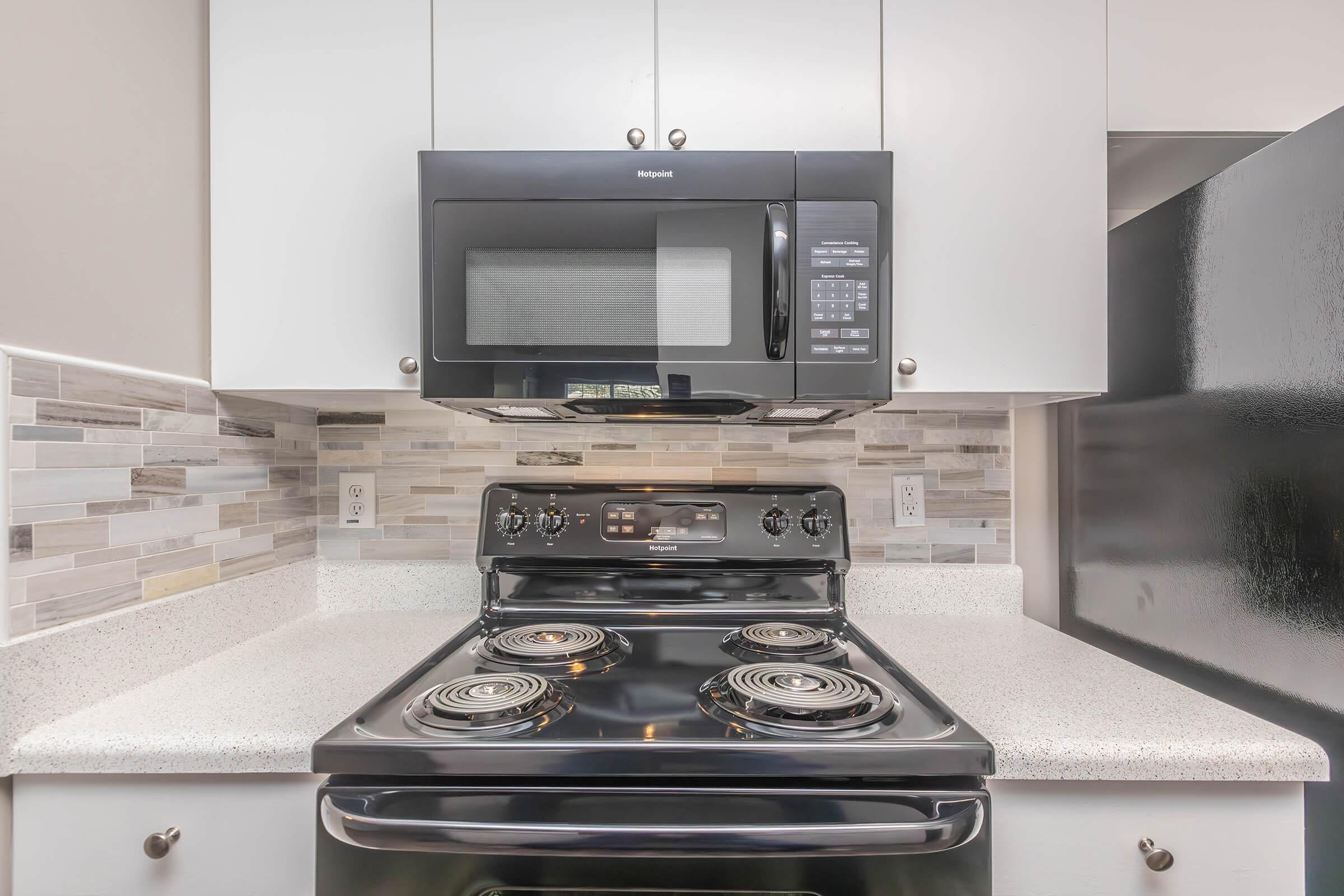 a microwave oven sitting on top of a stove