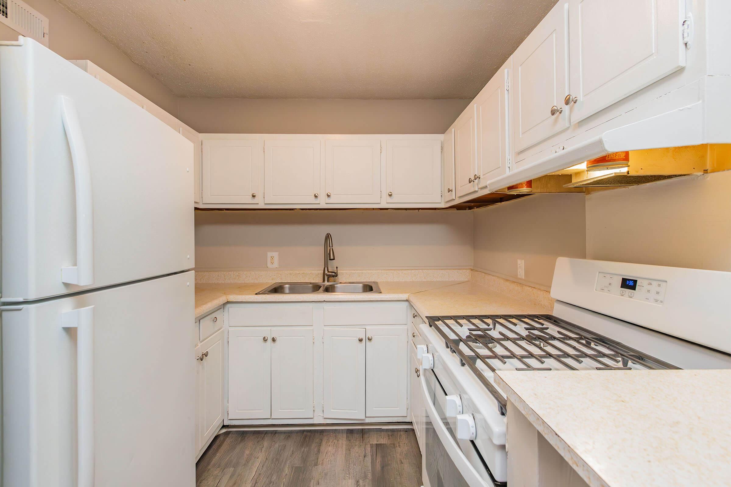 a kitchen with a stove and a refrigerator