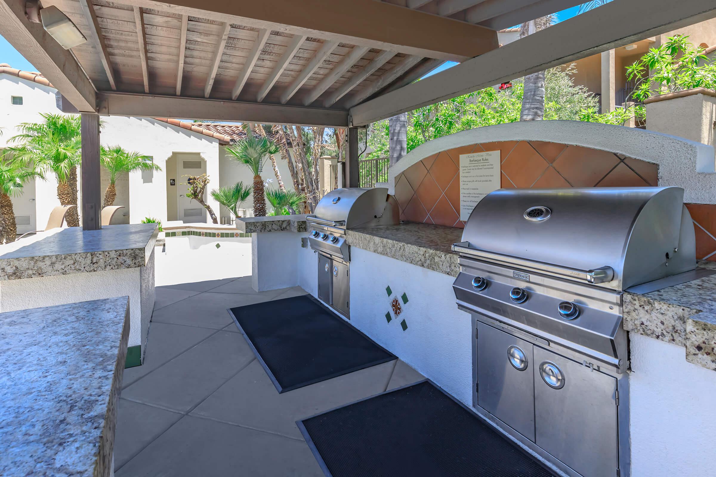 Stainless steel barbecues under a pavillion