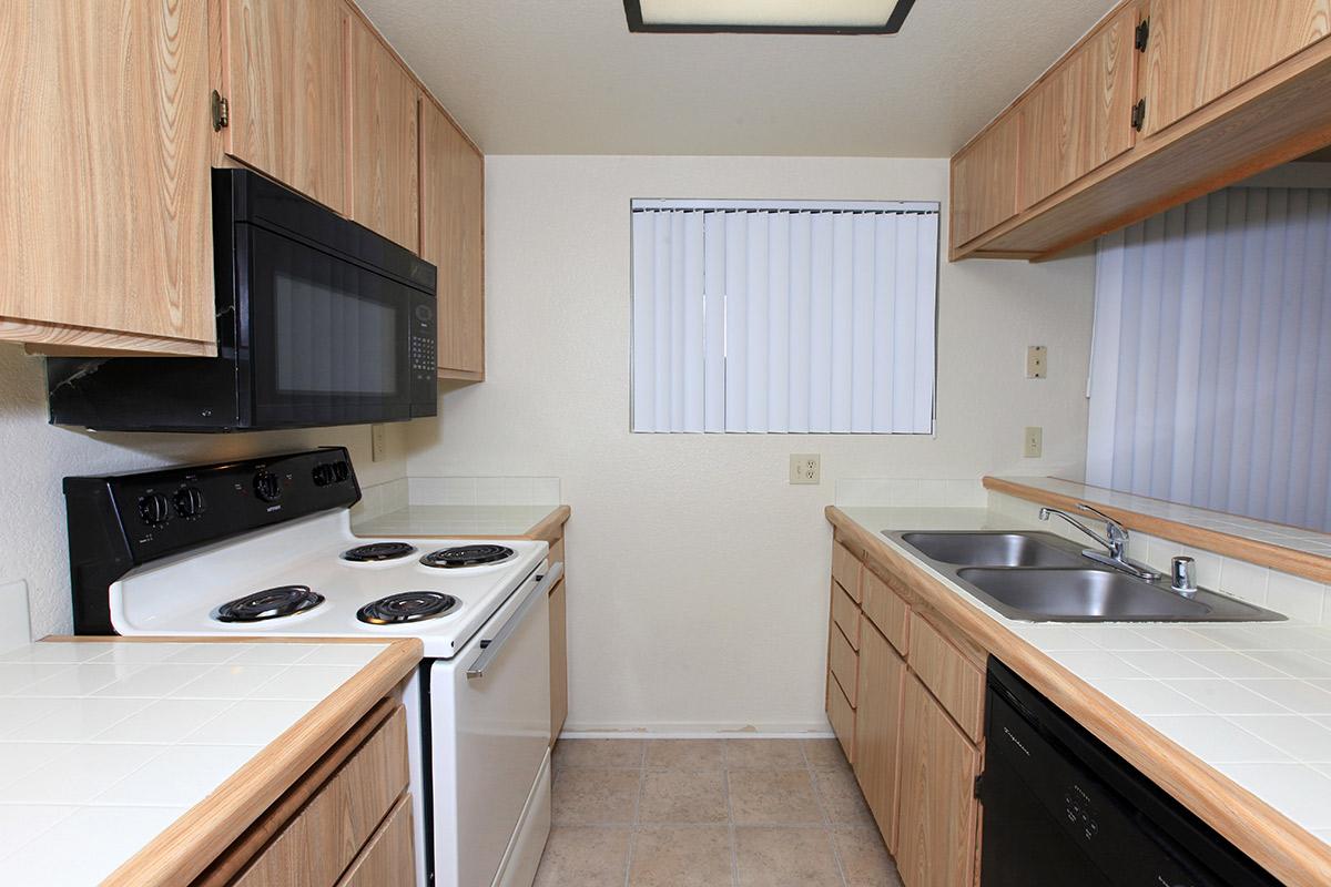 a kitchen with a stove a sink and a microwave