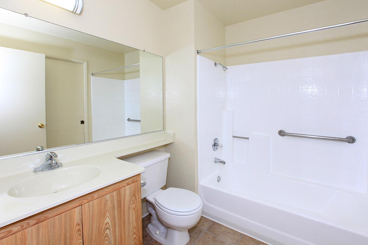 a large white tub sitting next to a sink