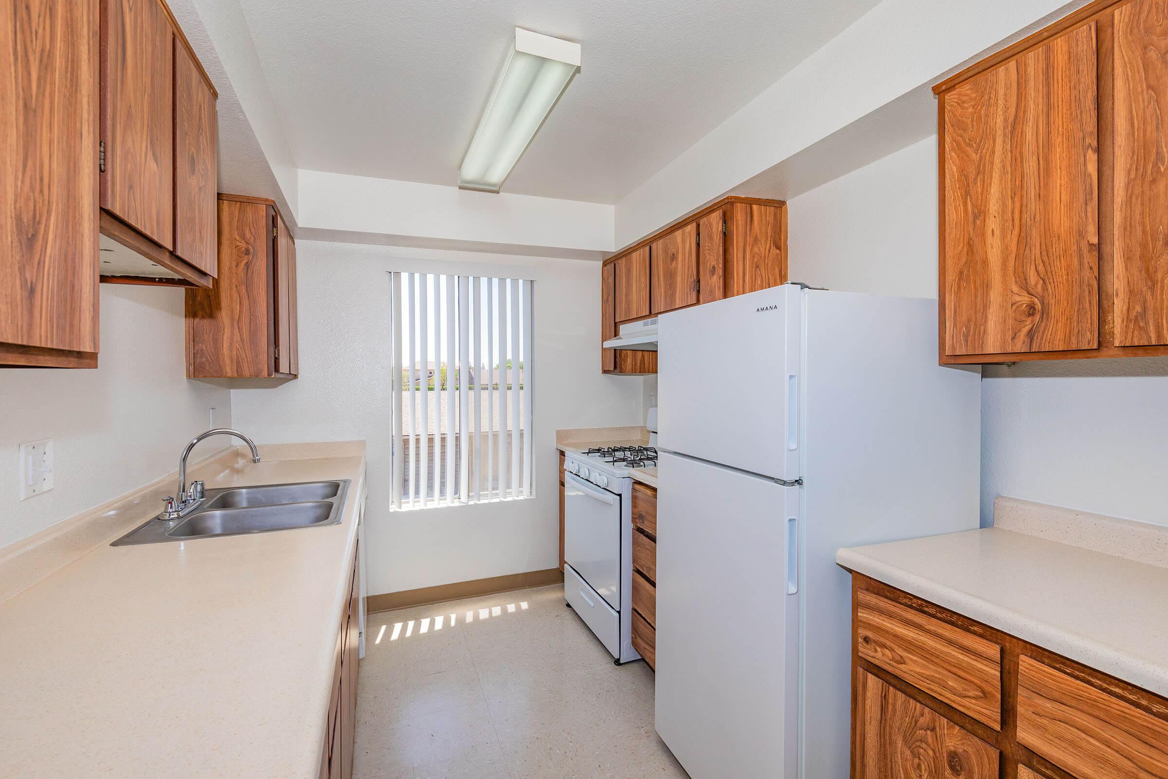 a kitchen with a stove and a refrigerator