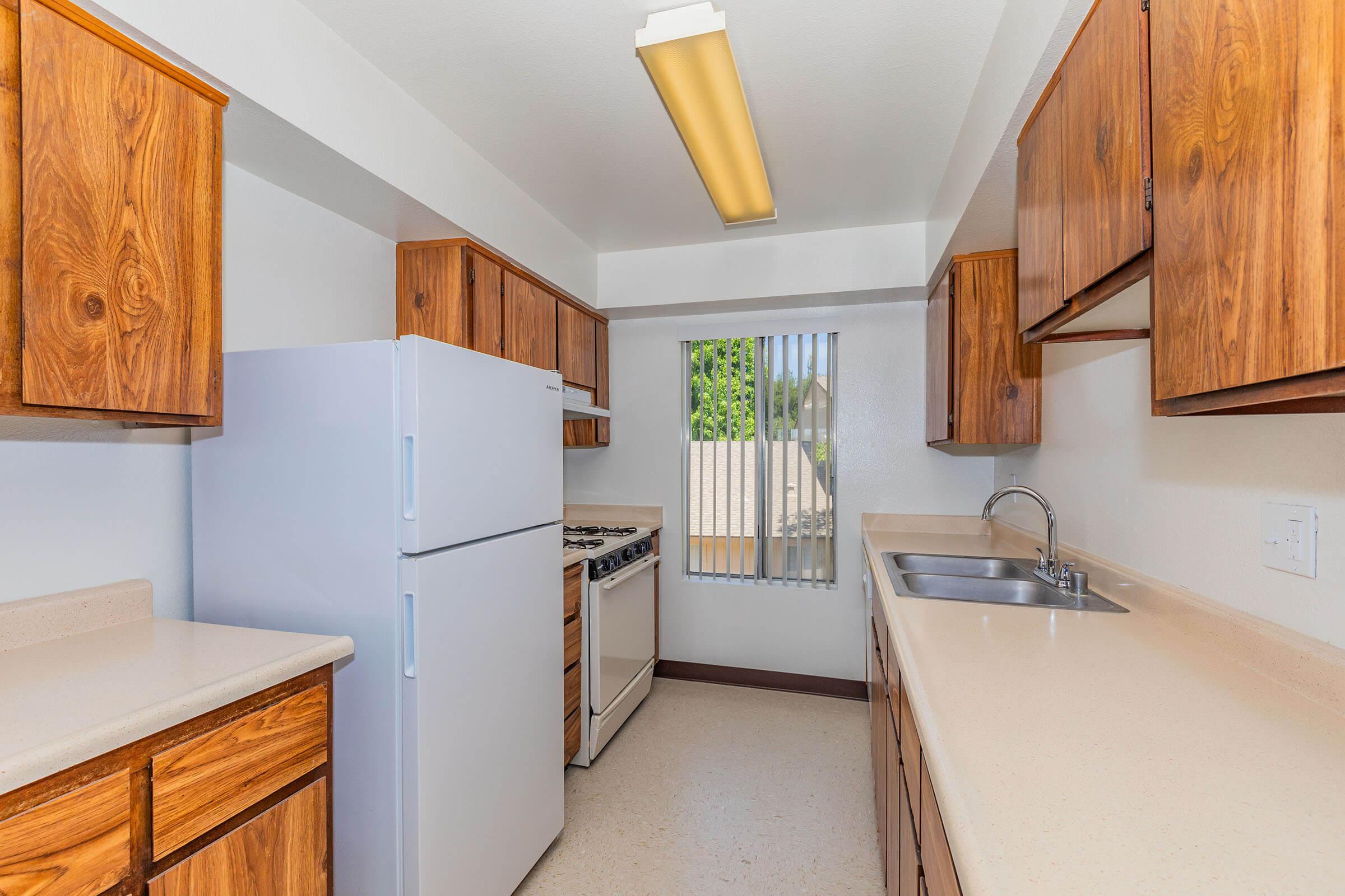 a kitchen with a sink and a refrigerator