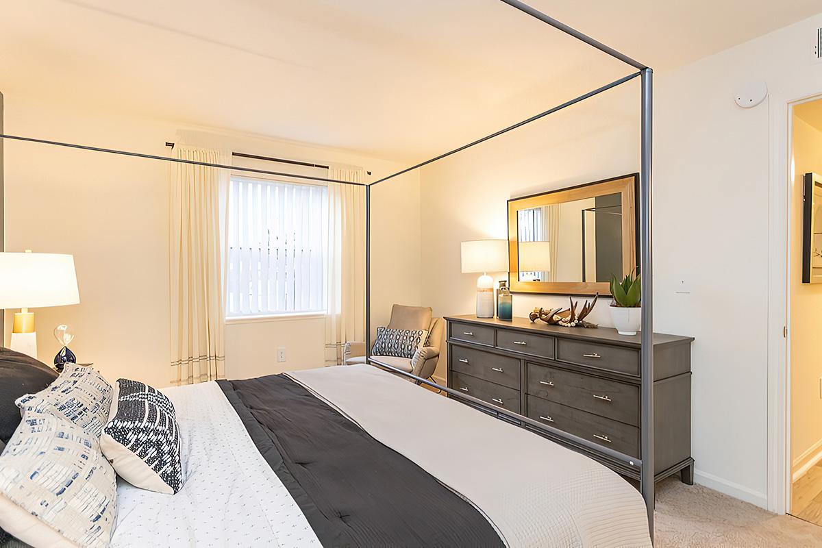 a bedroom with a bed in a room