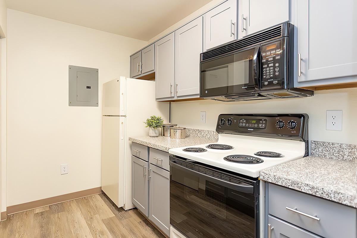 a stove top oven sitting inside of a kitchen