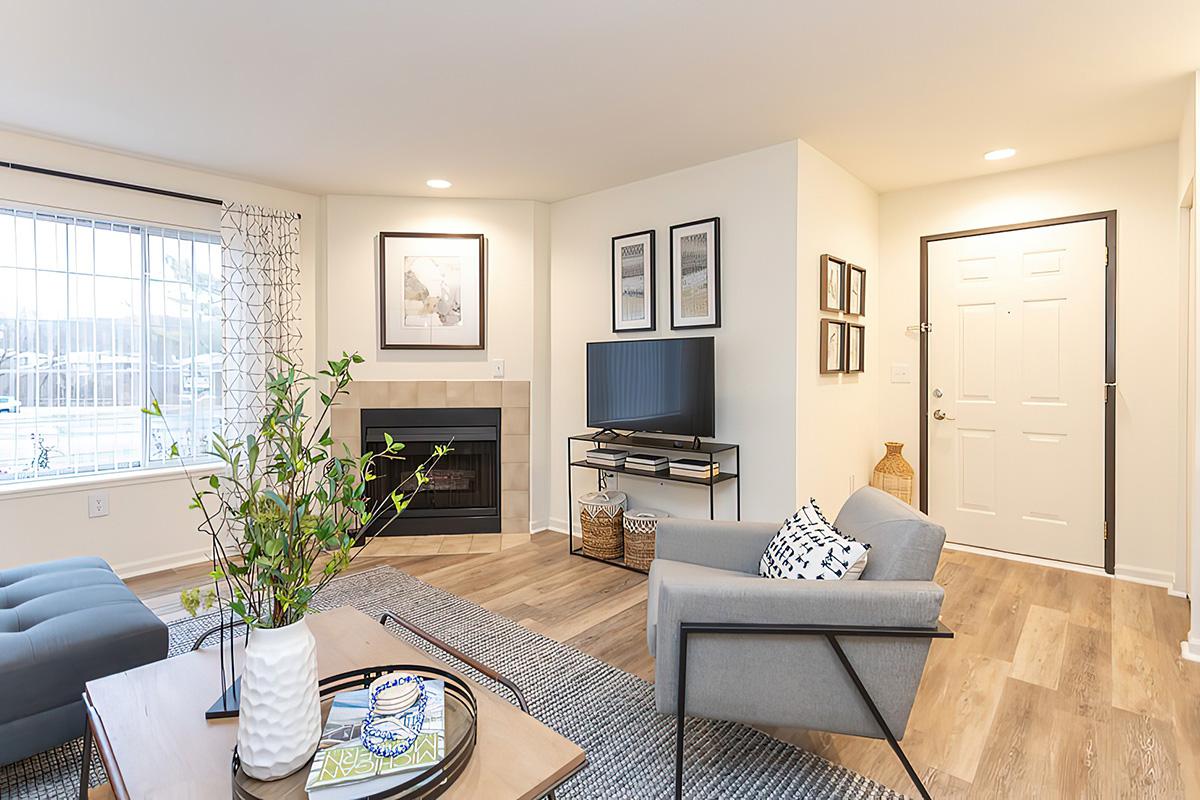 a living room filled with furniture and a large window
