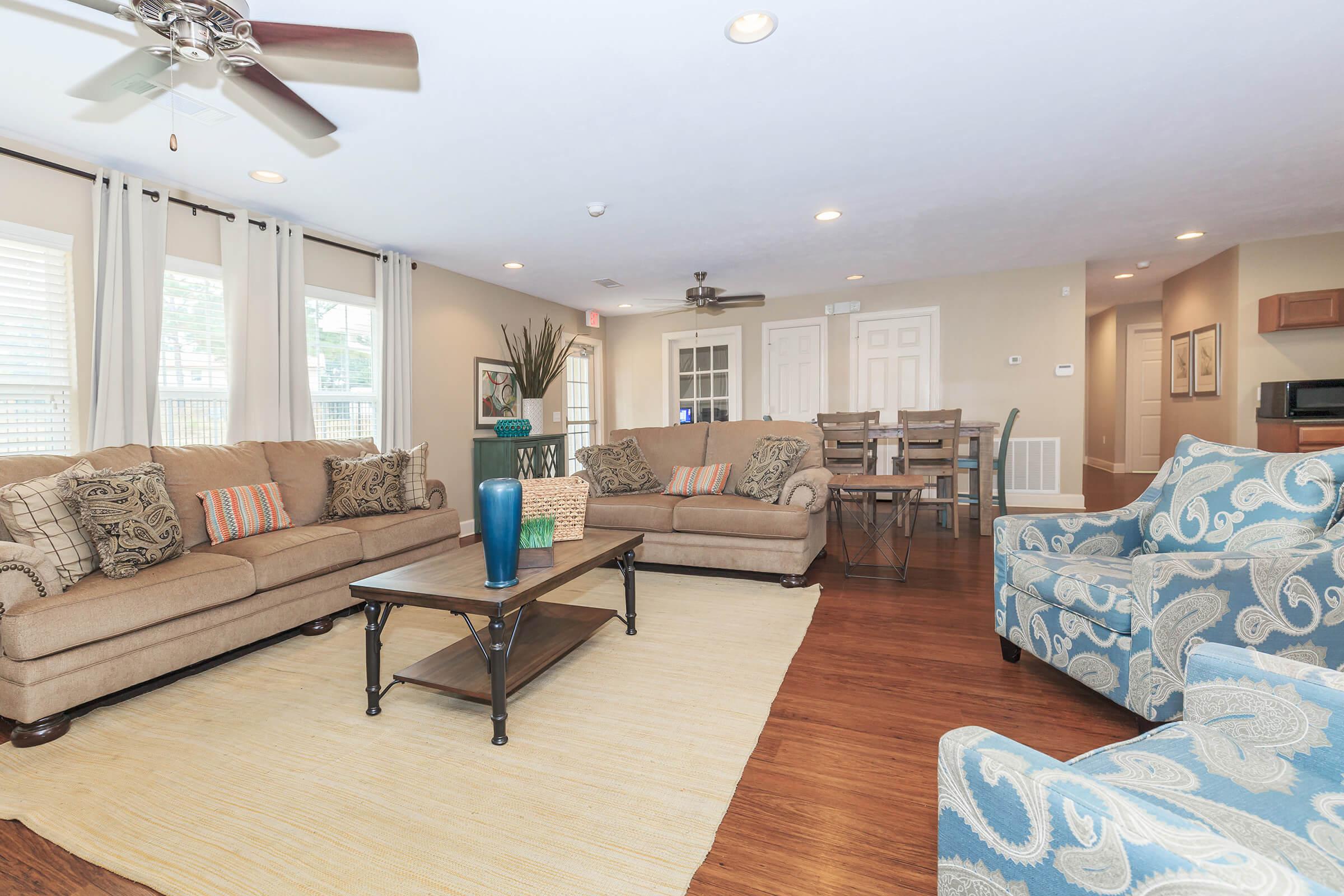 a living room filled with furniture and a large window