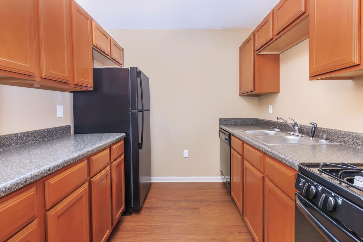 a kitchen with stainless steel appliances and wooden cabinets