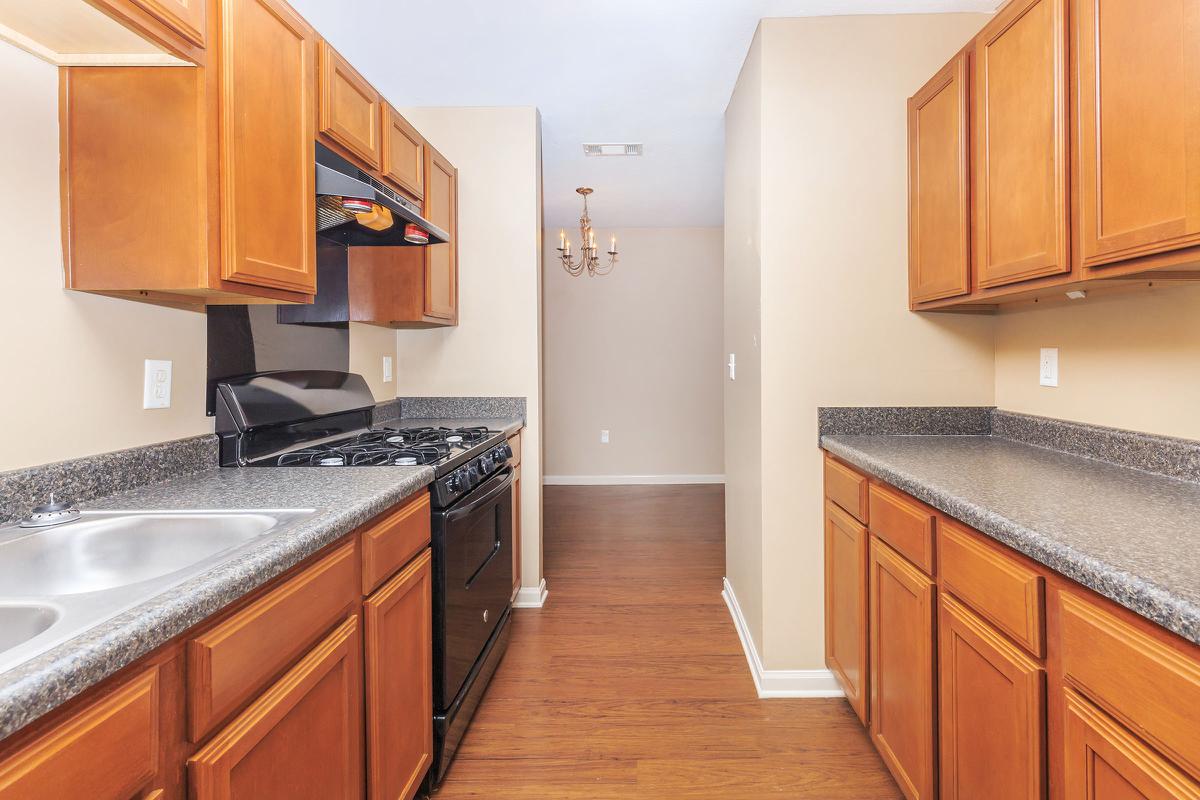 a kitchen with stainless steel appliances and wooden cabinets