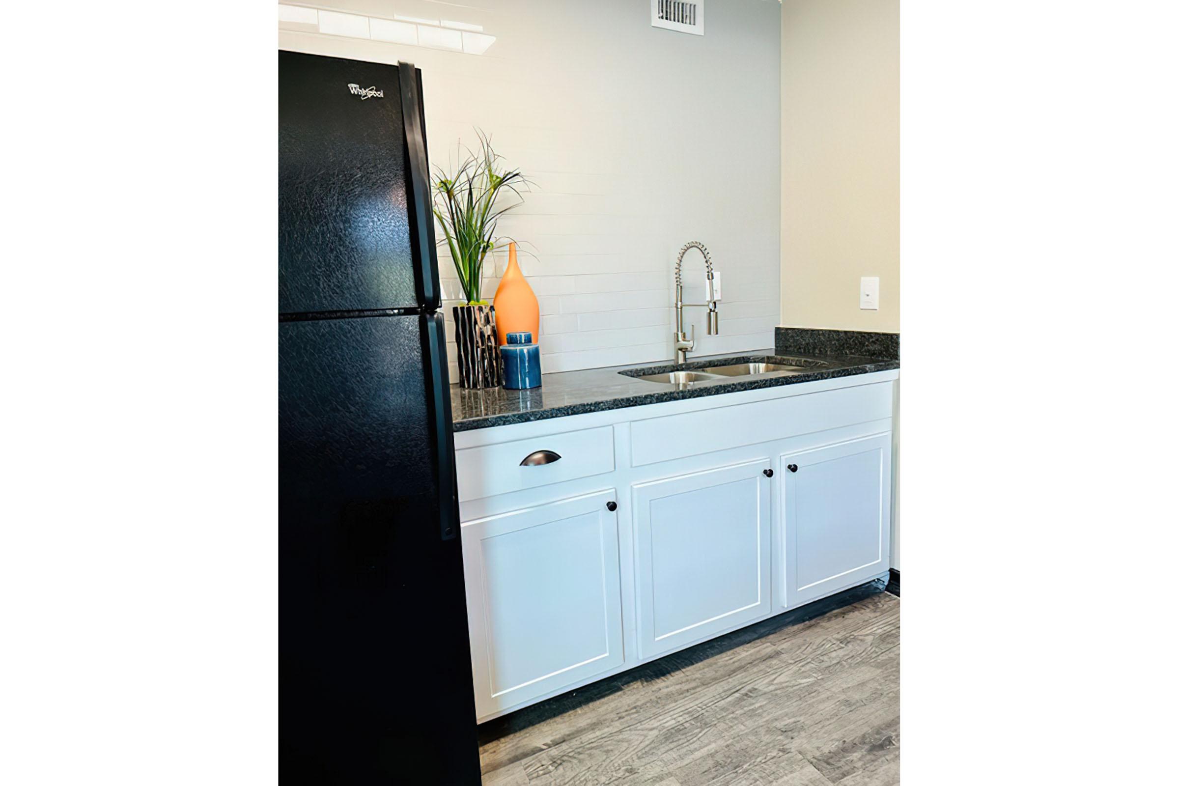 a kitchen with a sink and a refrigerator