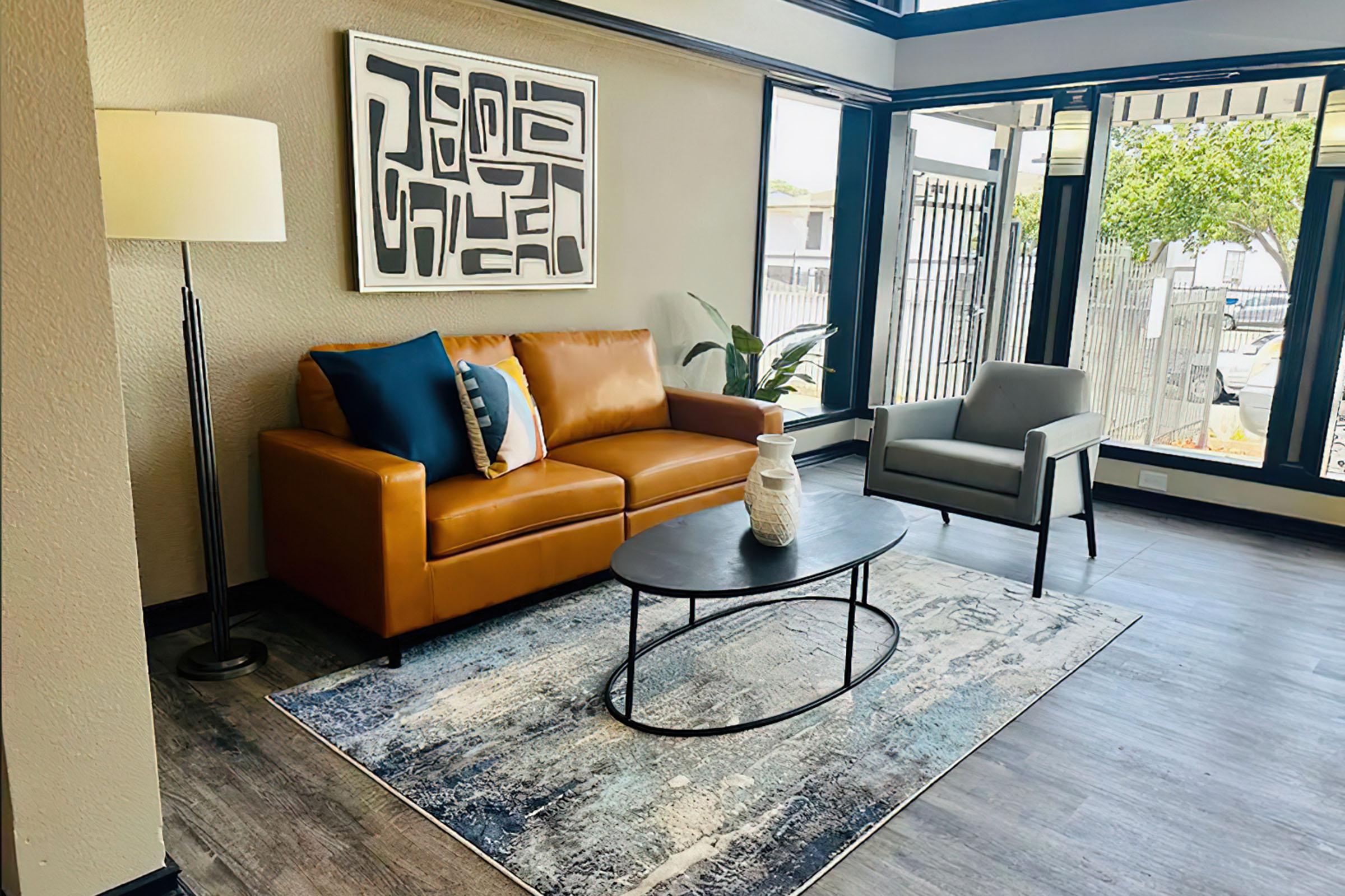 a living room filled with furniture and a large window