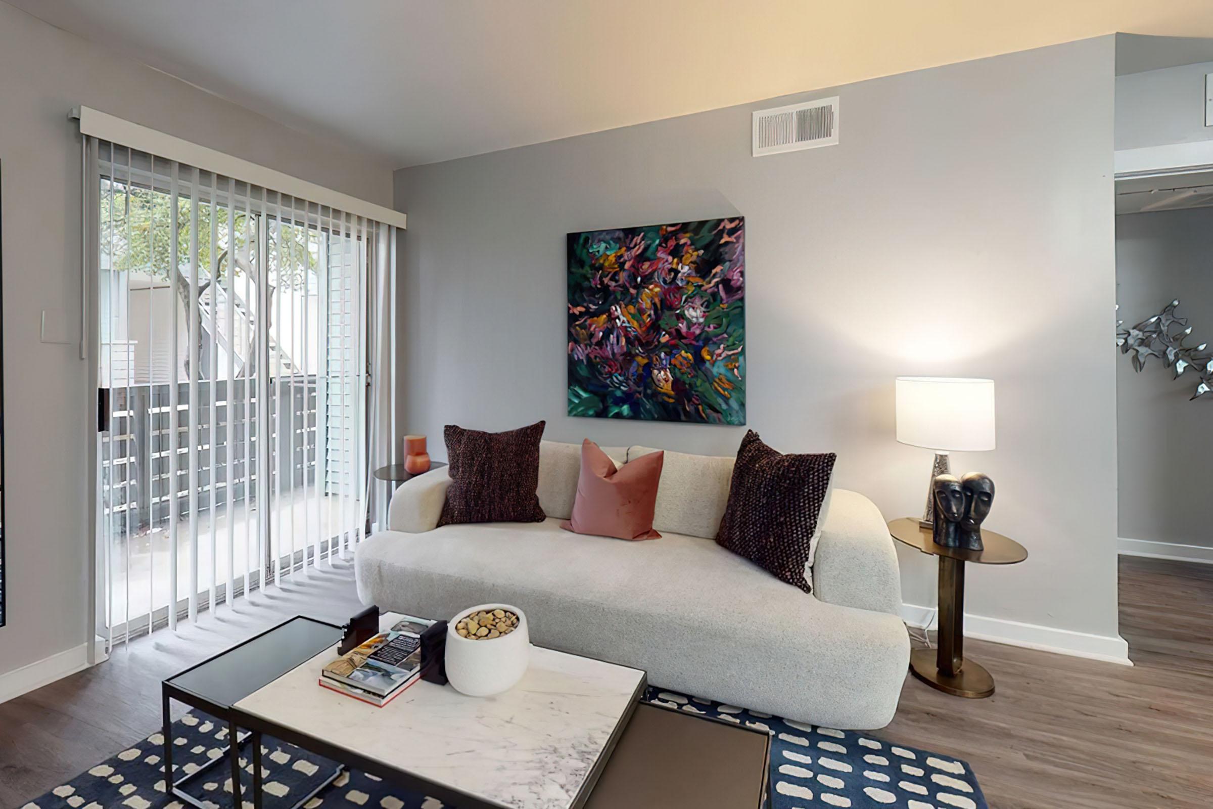 a living room filled with furniture and a flat screen tv