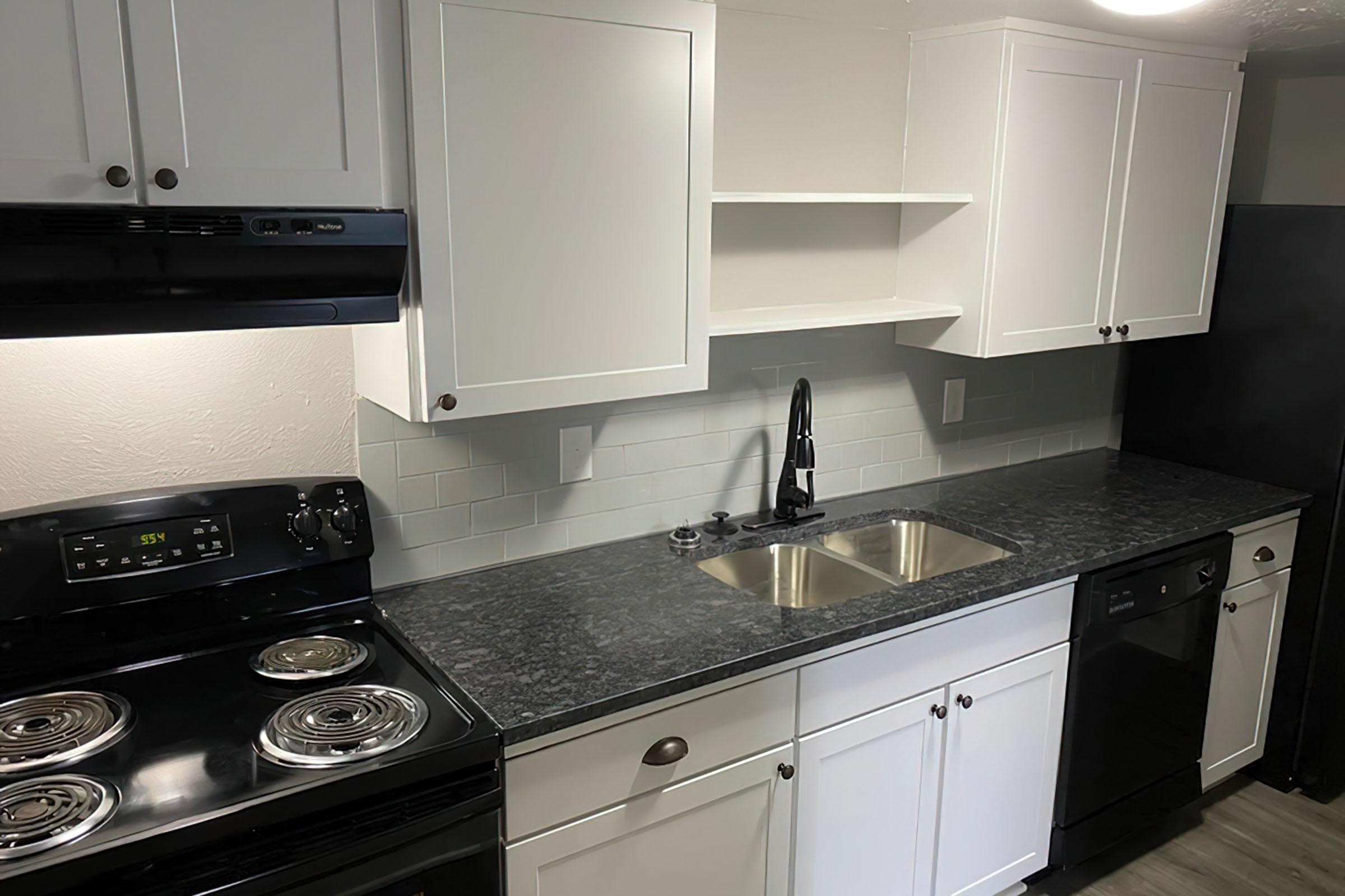 a stove top oven sitting inside of a kitchen