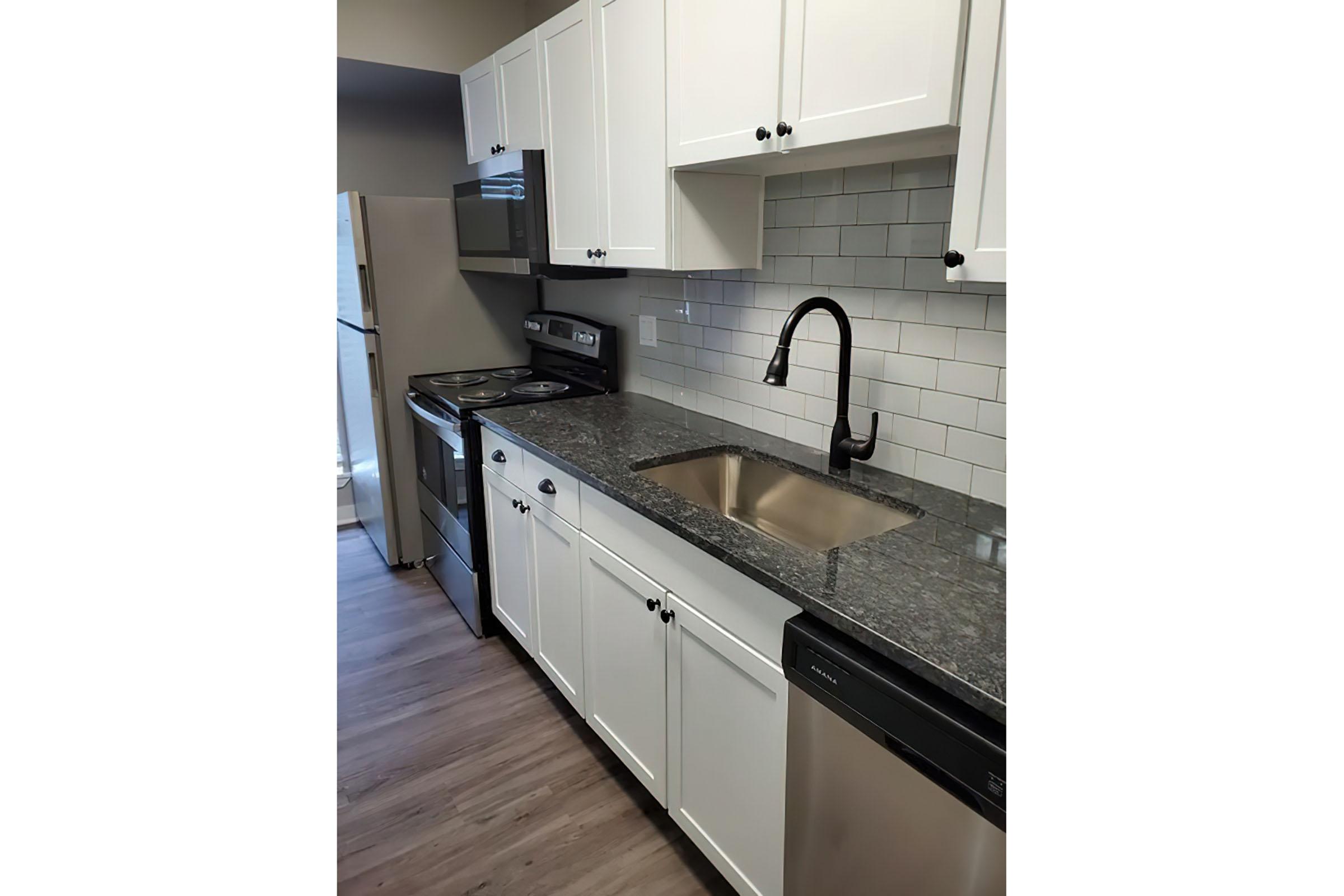 a kitchen with a stove and a sink