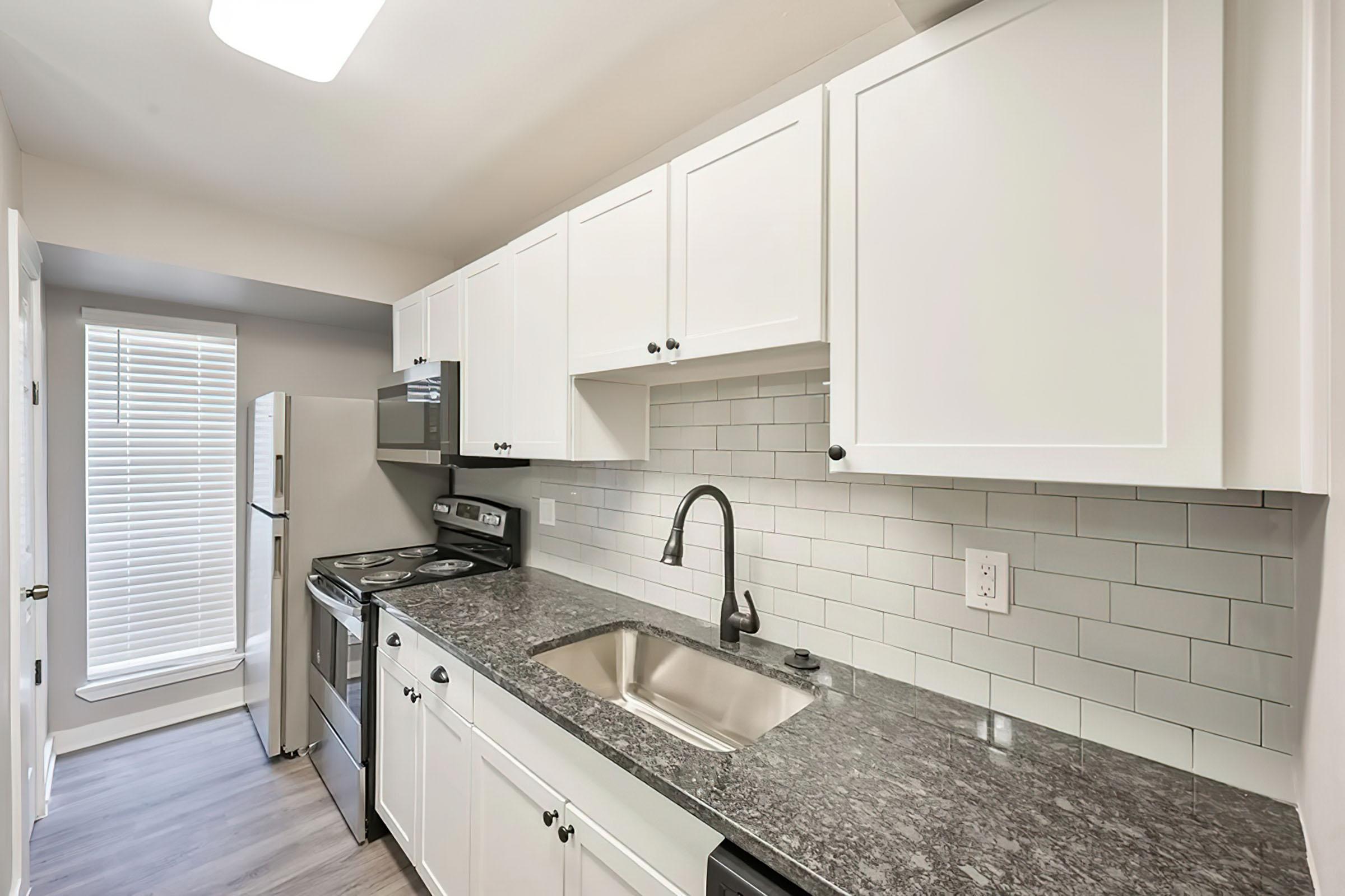 a kitchen with a sink and a window