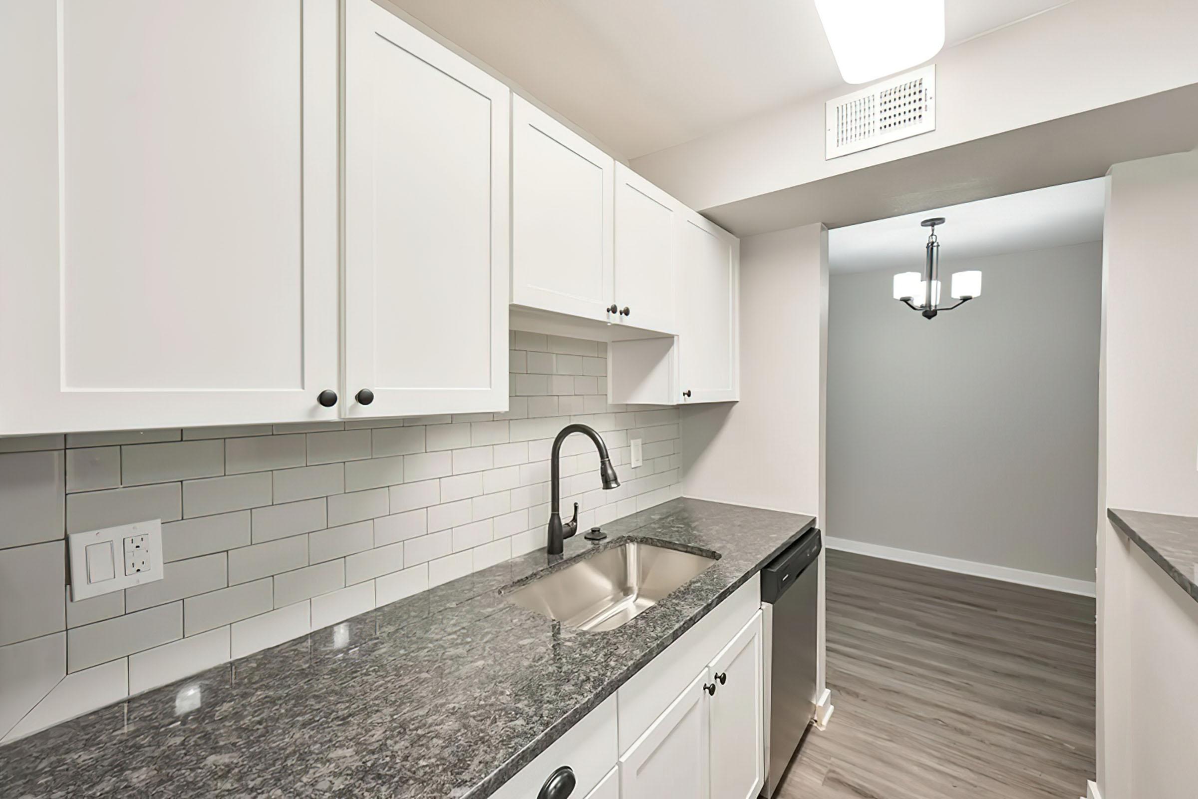 a kitchen with a sink and a mirror