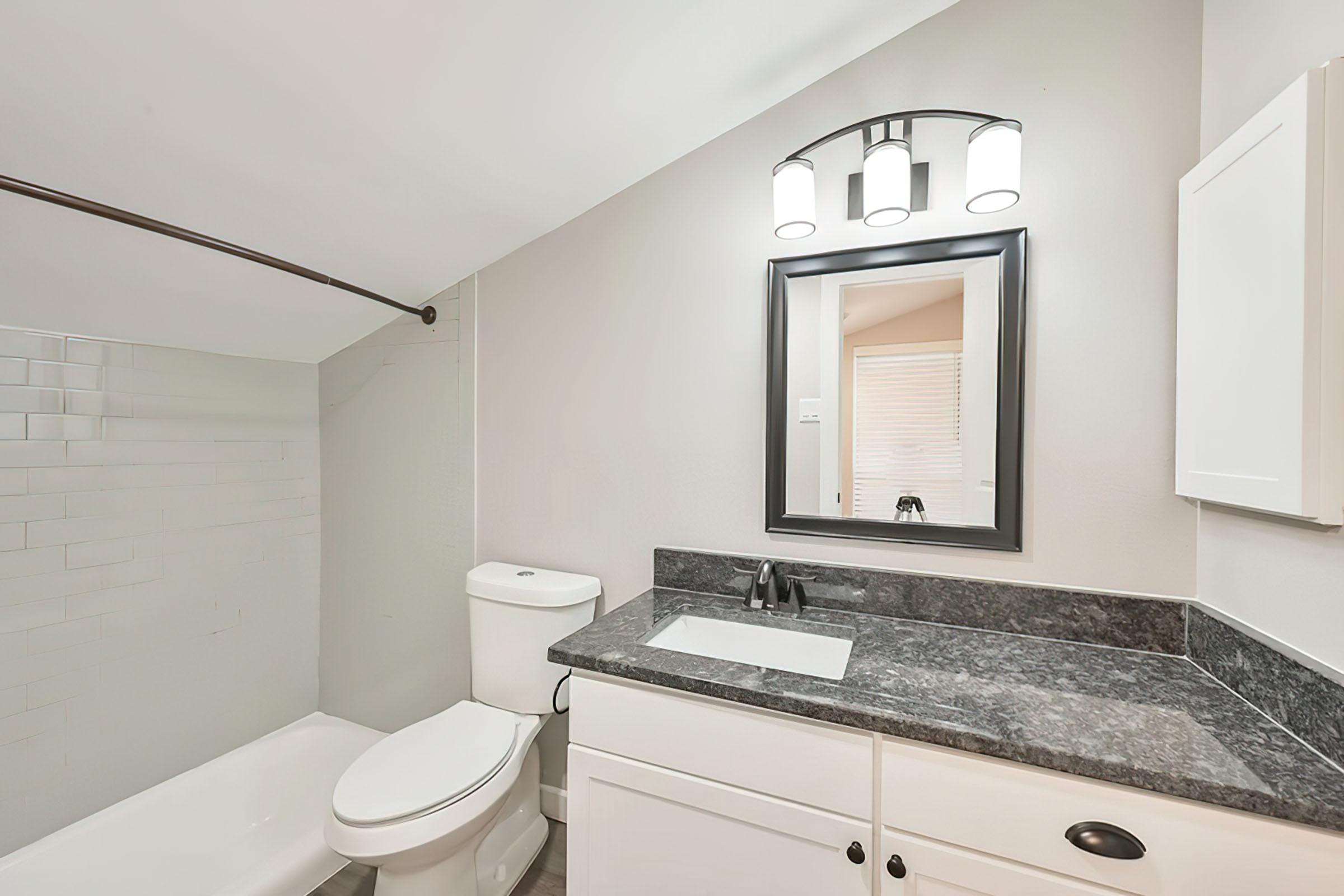 a kitchen with a sink and a mirror