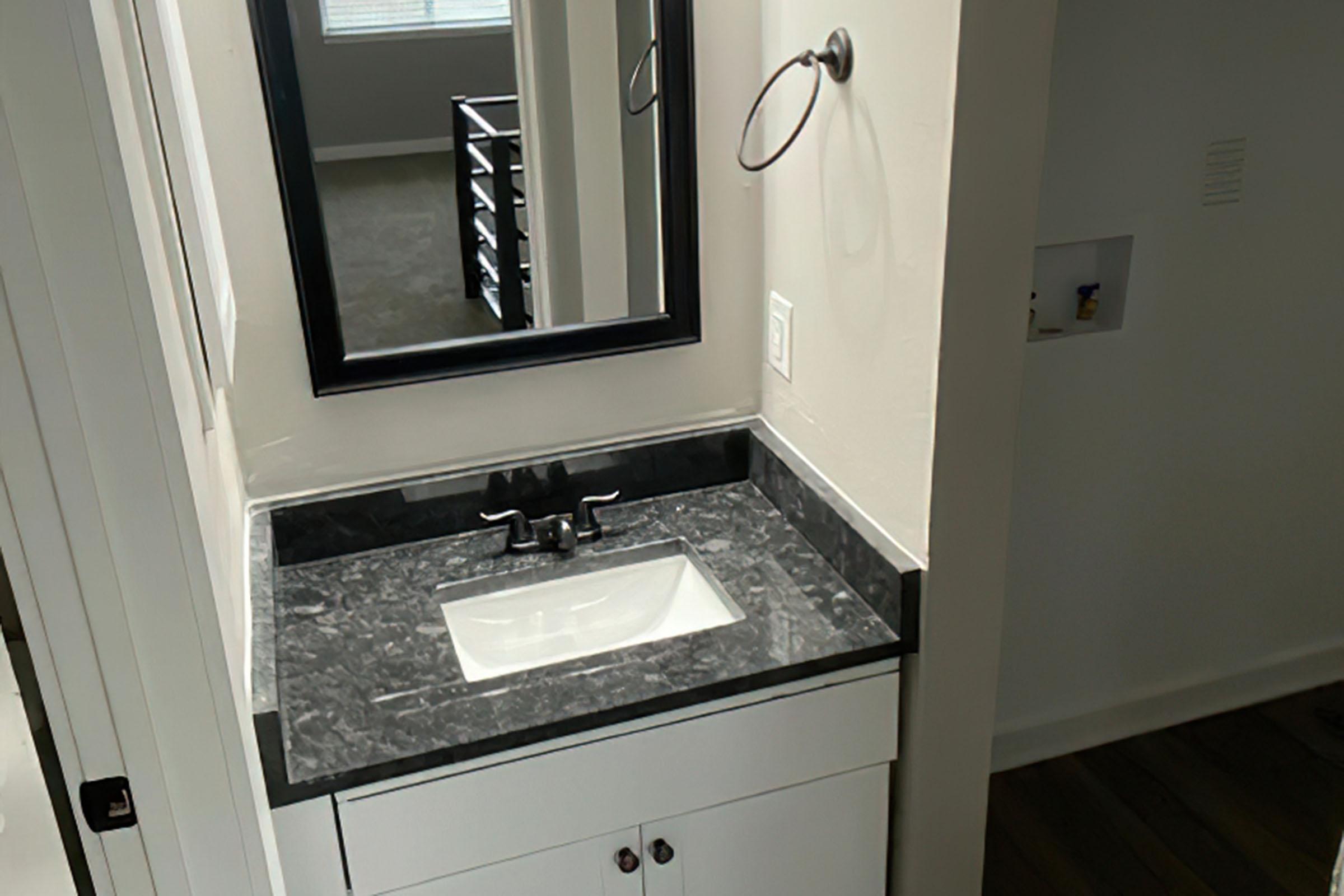 a kitchen with a sink and a mirror