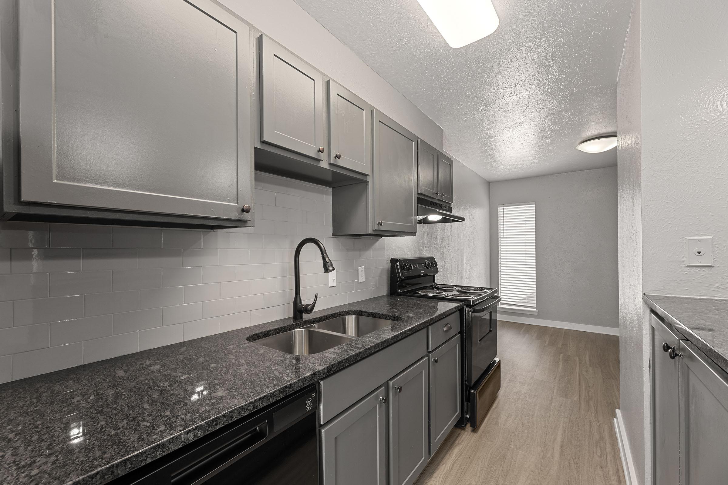 a kitchen with a sink and a mirror