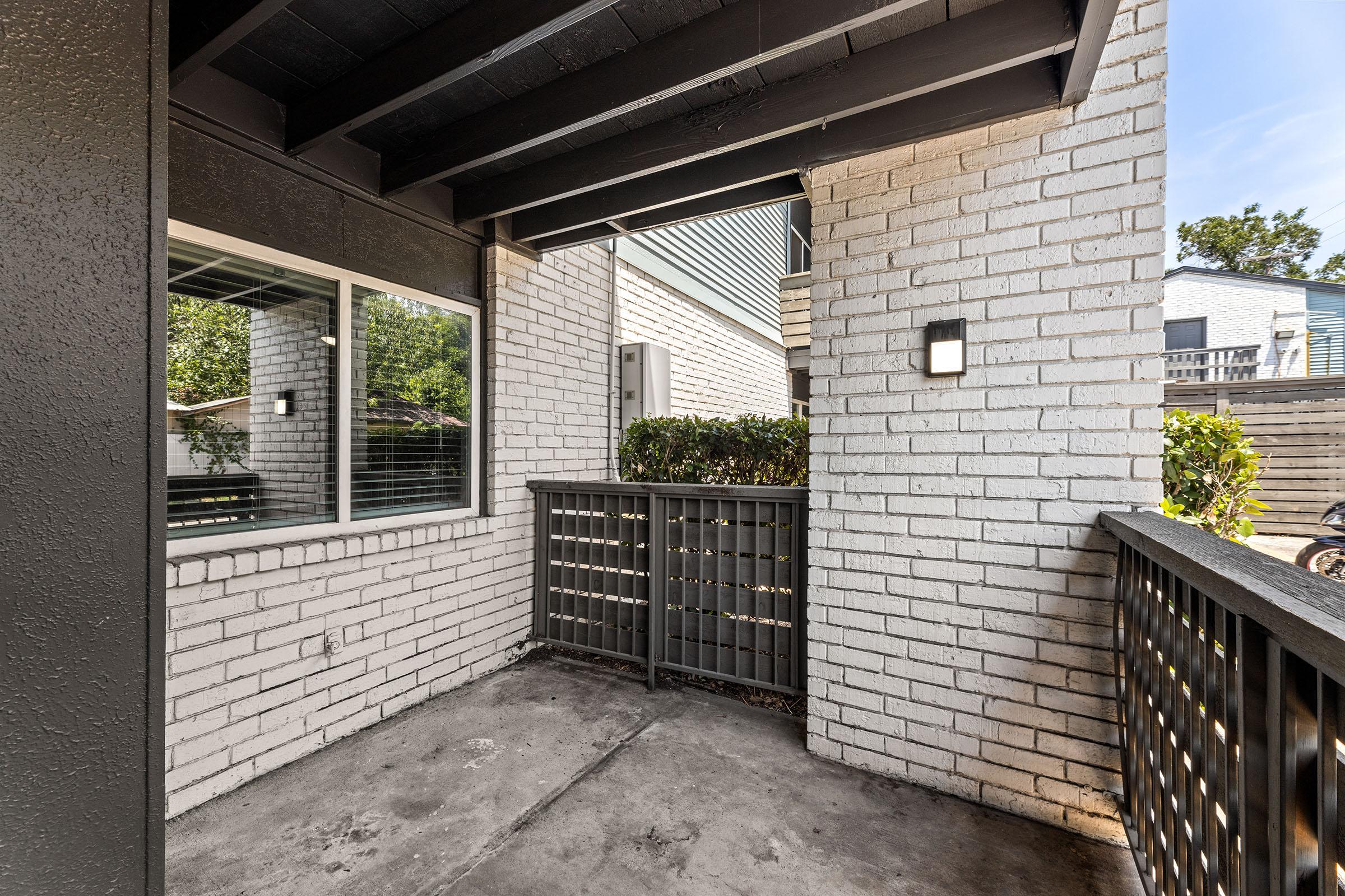 a bench in front of a brick building