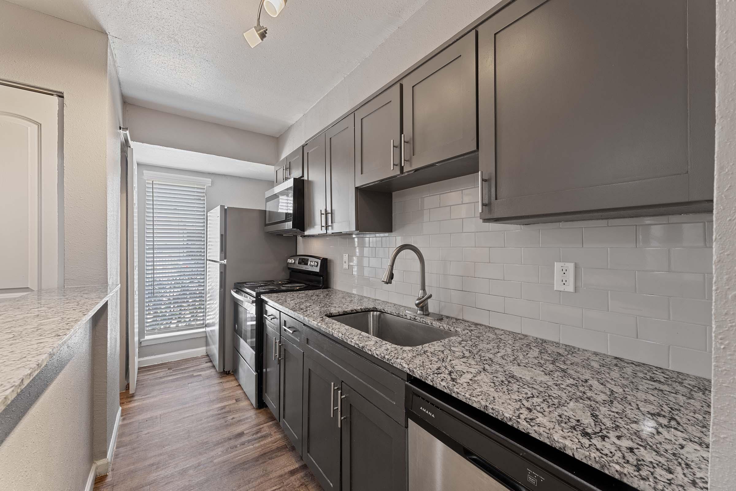 a kitchen with a sink and a mirror