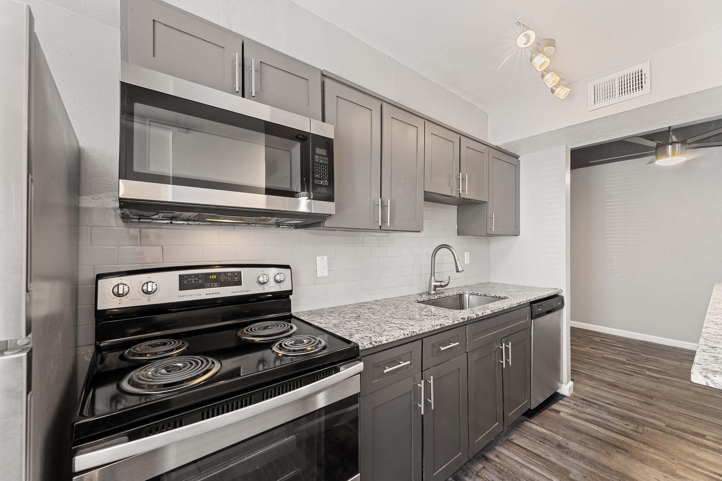 a stove top oven sitting inside of a kitchen