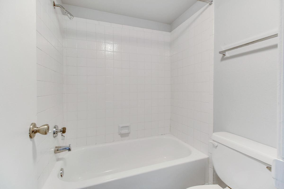 a white tub sitting next to a sink