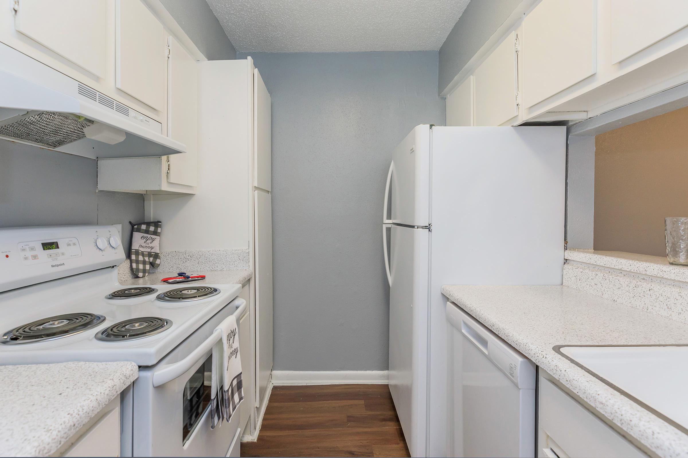 a kitchen with a stove sink and refrigerator