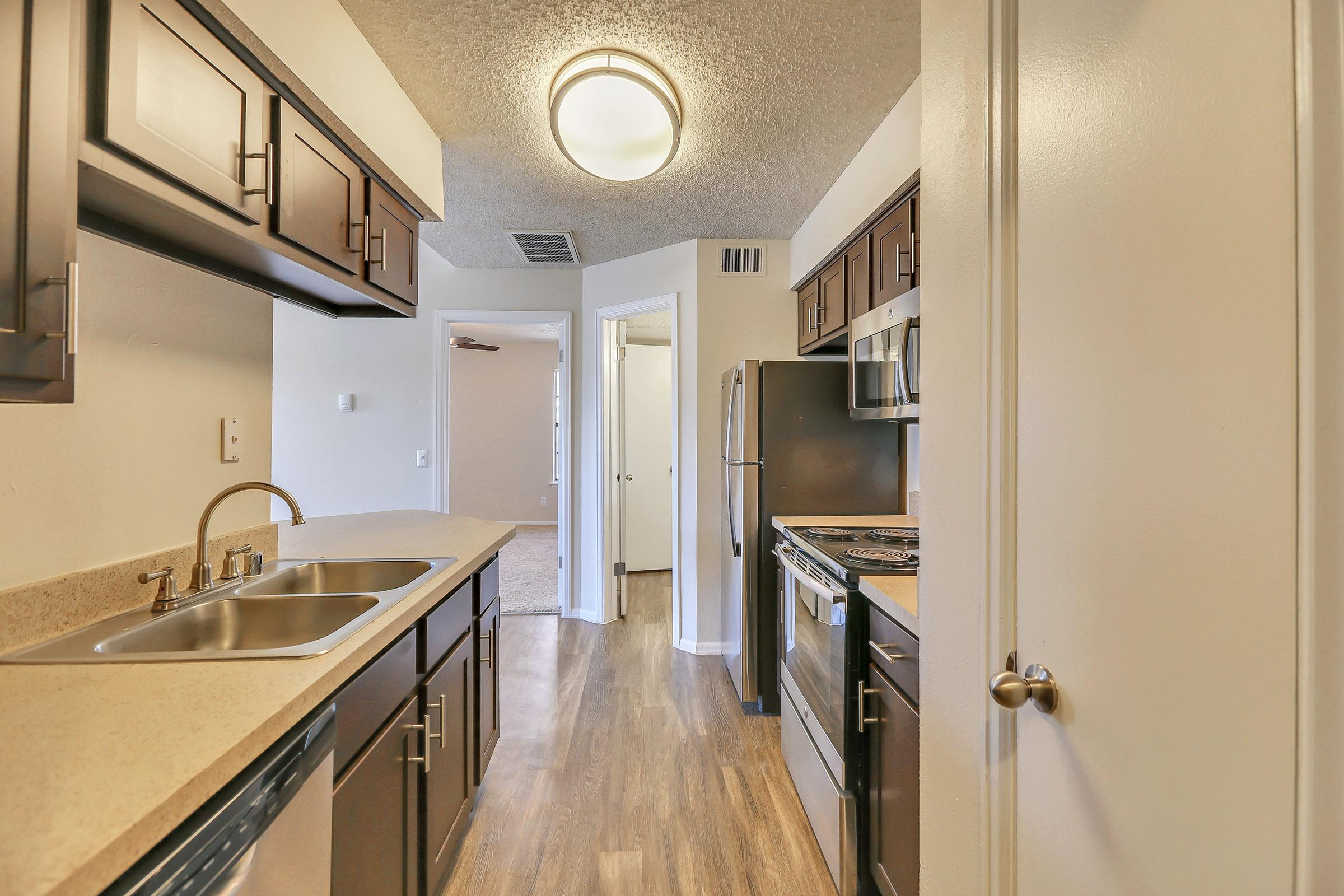 a kitchen with a sink and a mirror