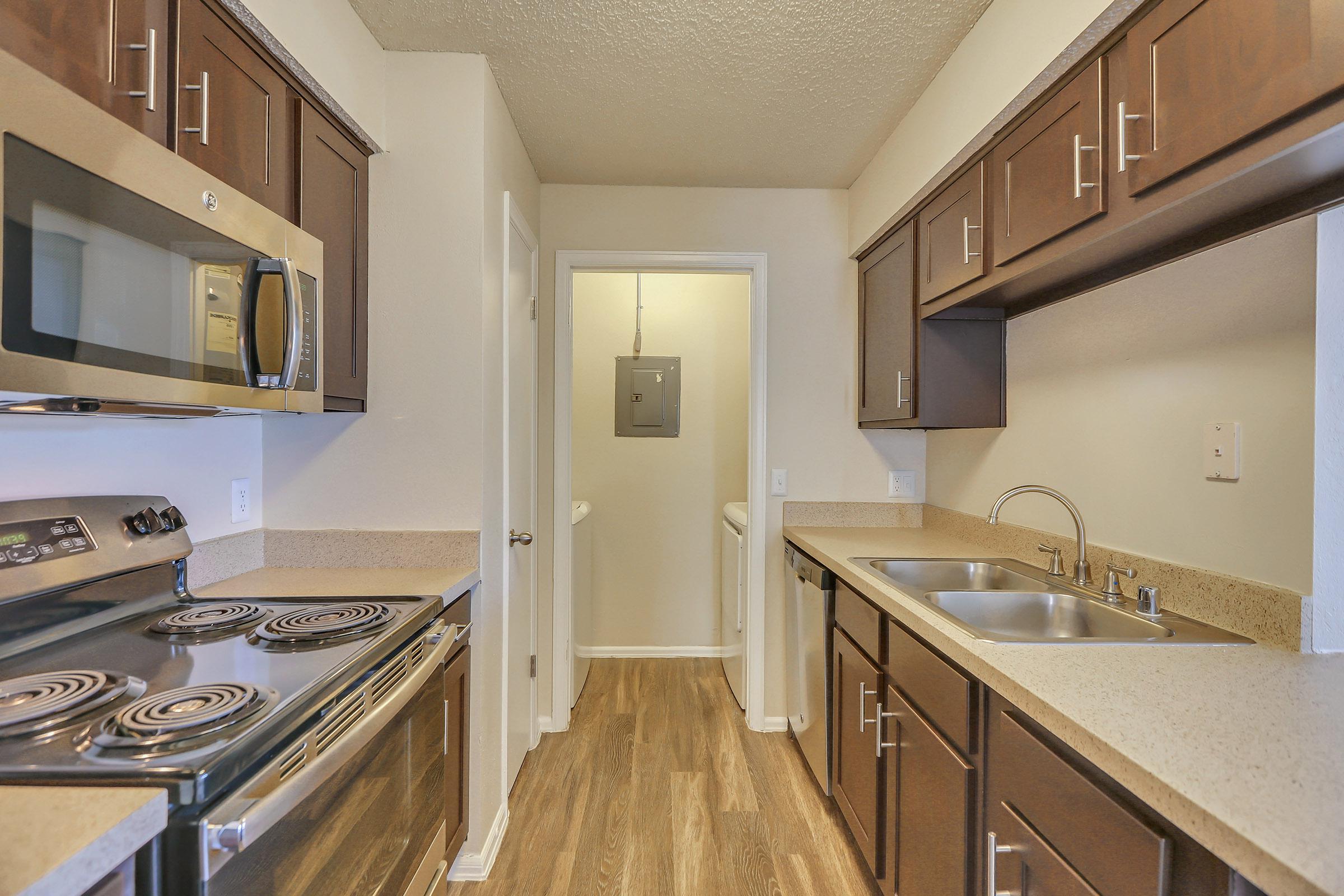 a kitchen with a sink and a mirror