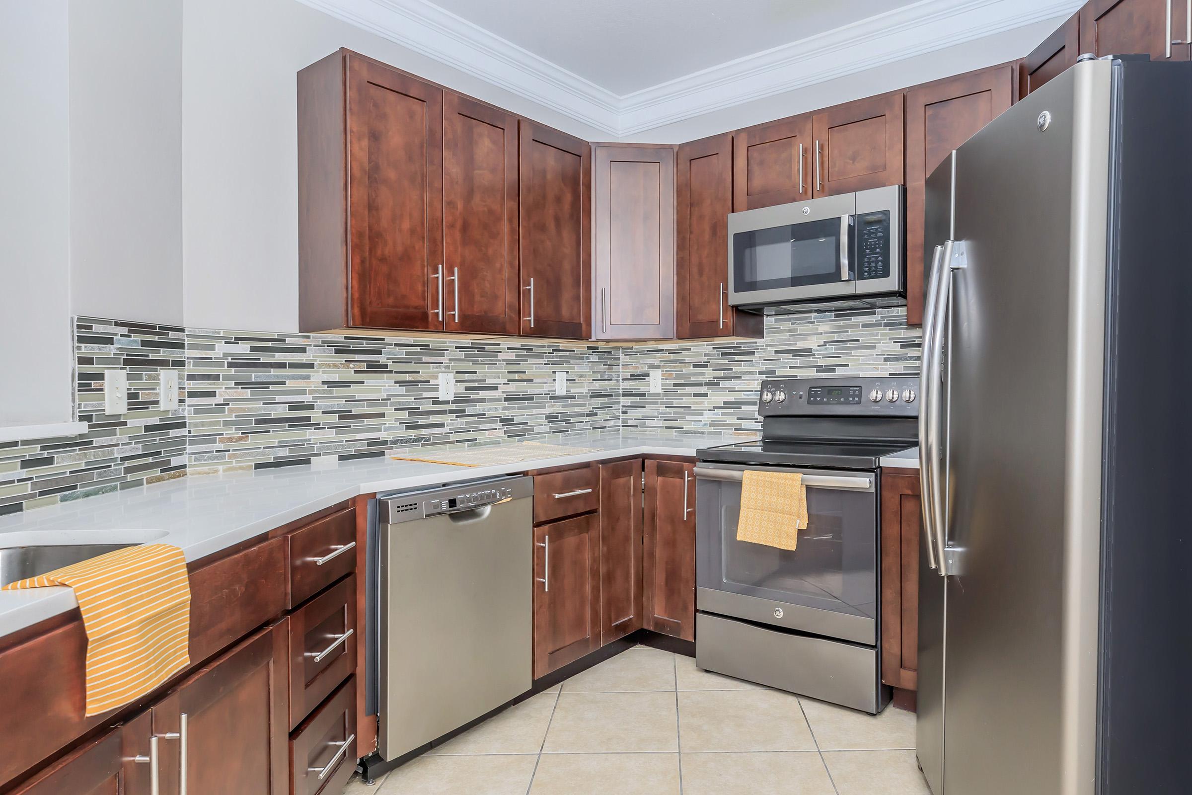 a kitchen with stainless steel appliances and wooden cabinets