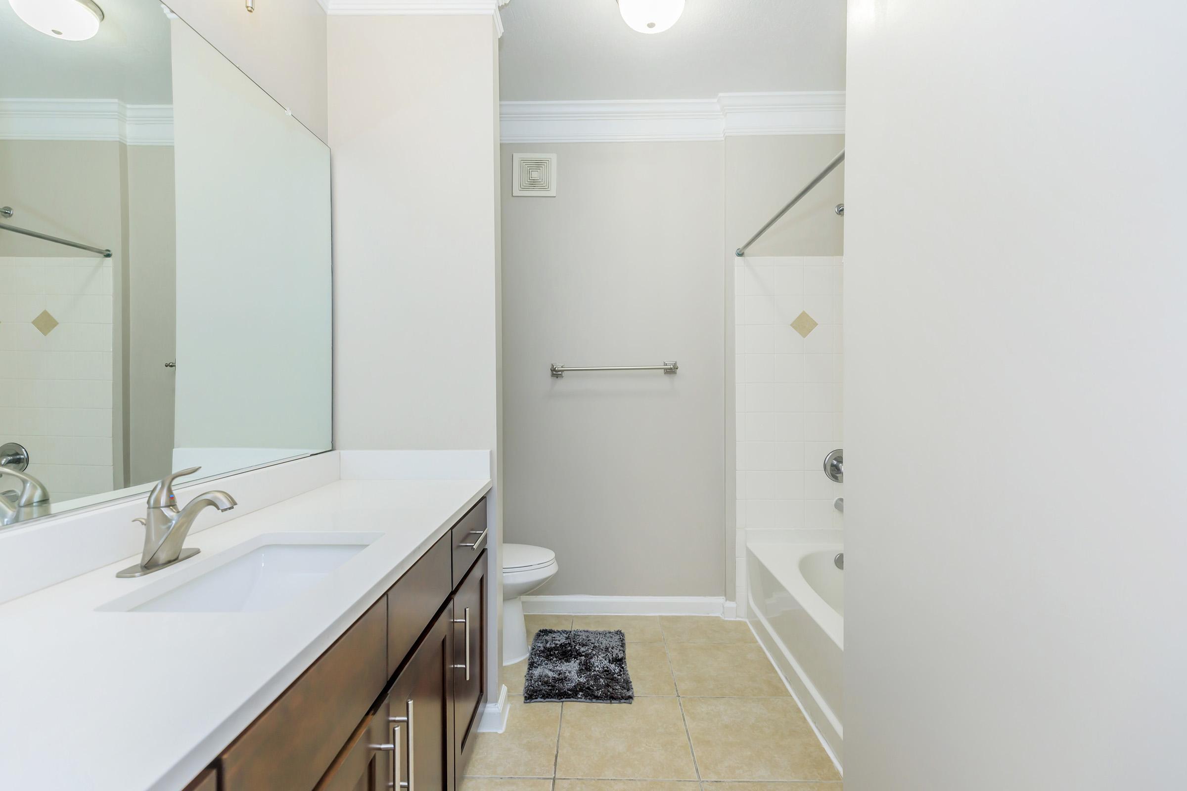 a kitchen with a sink and a mirror