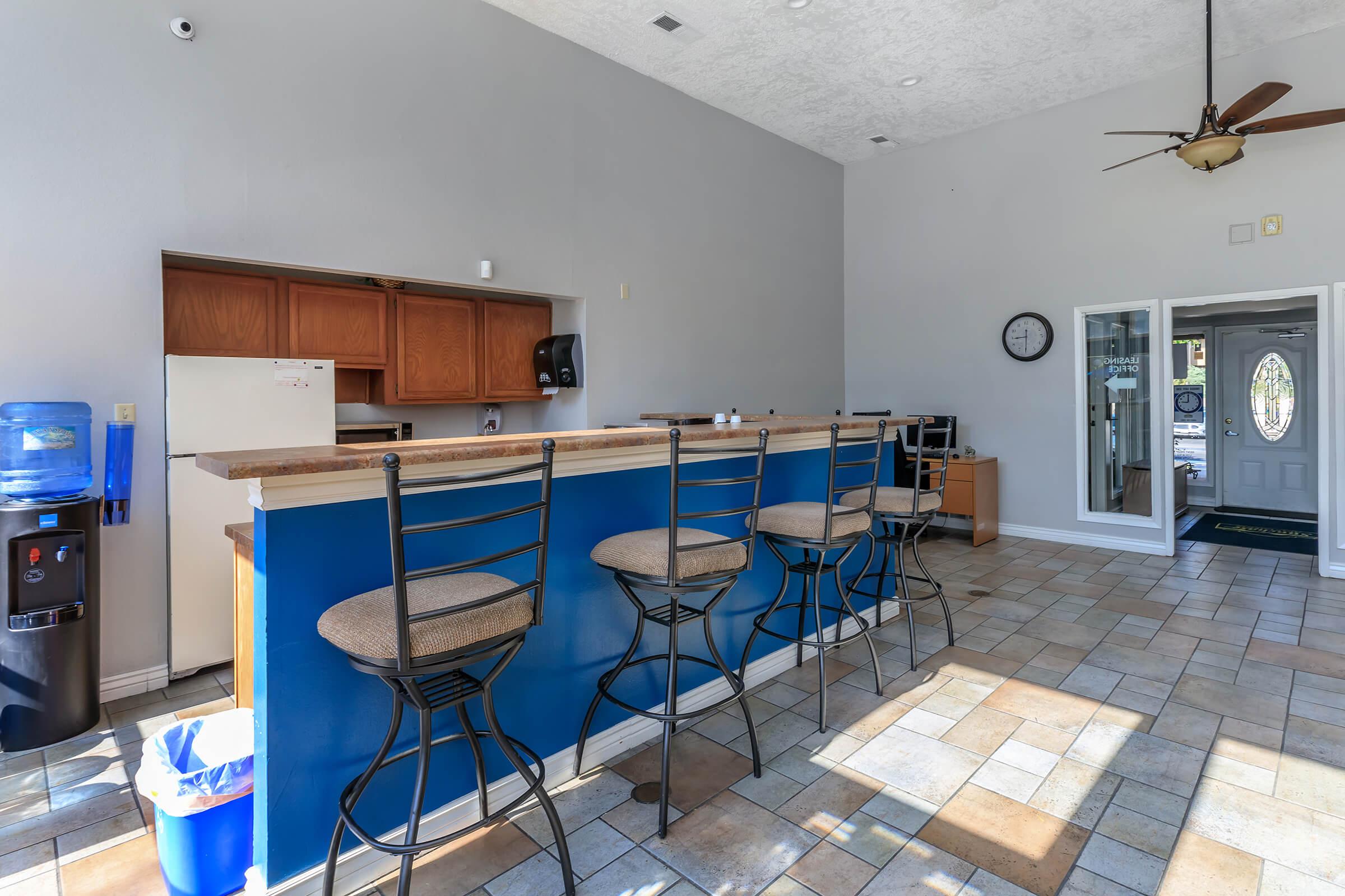 a kitchen with a blue chair