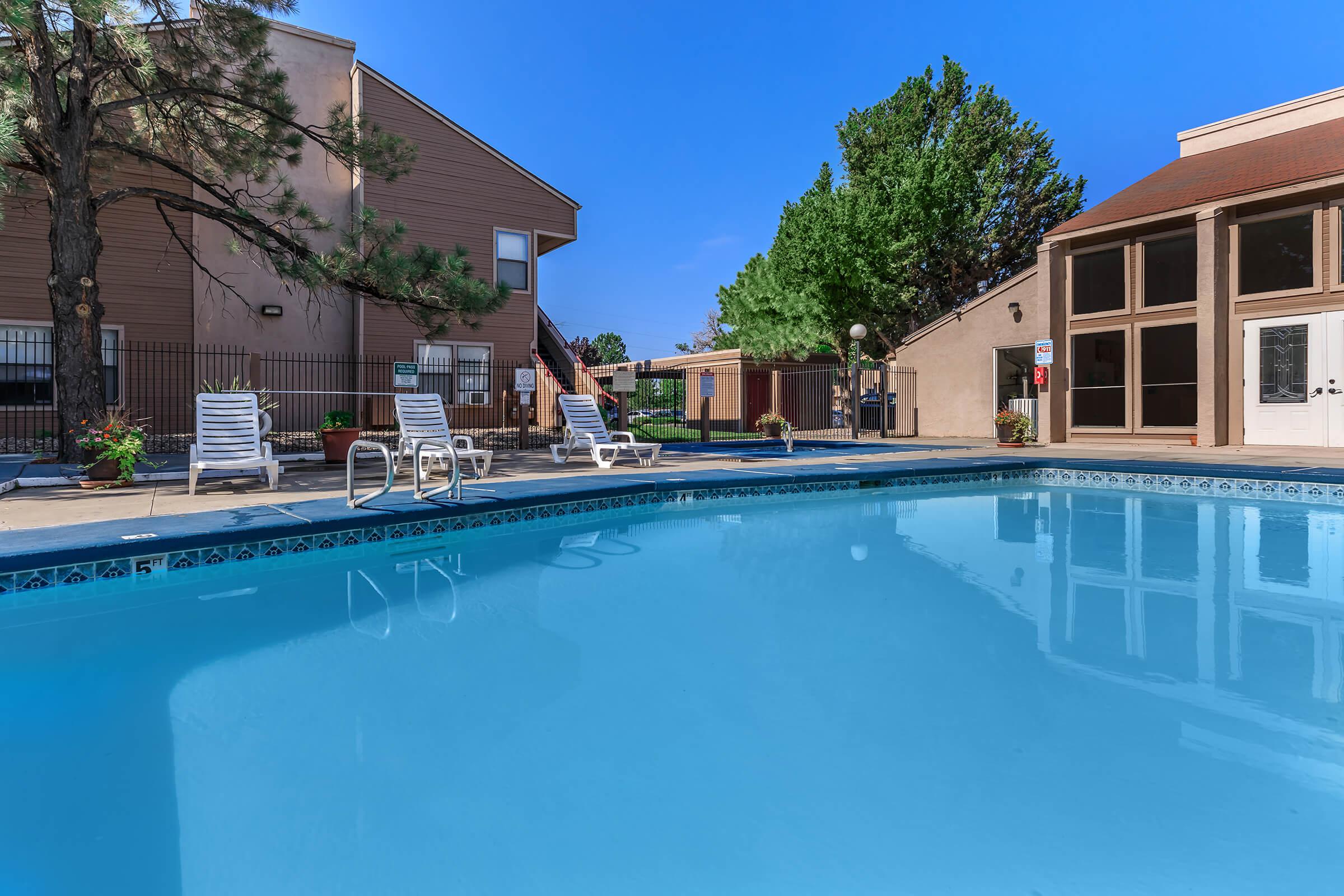 the community pool with green trees