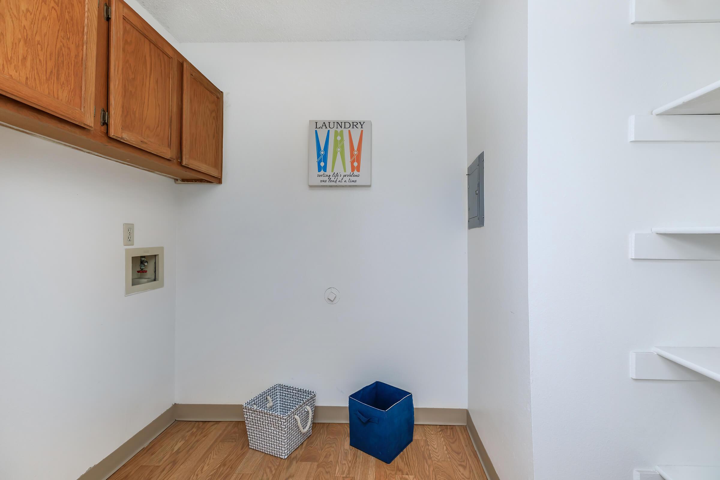 walk-in closet with wooden floors