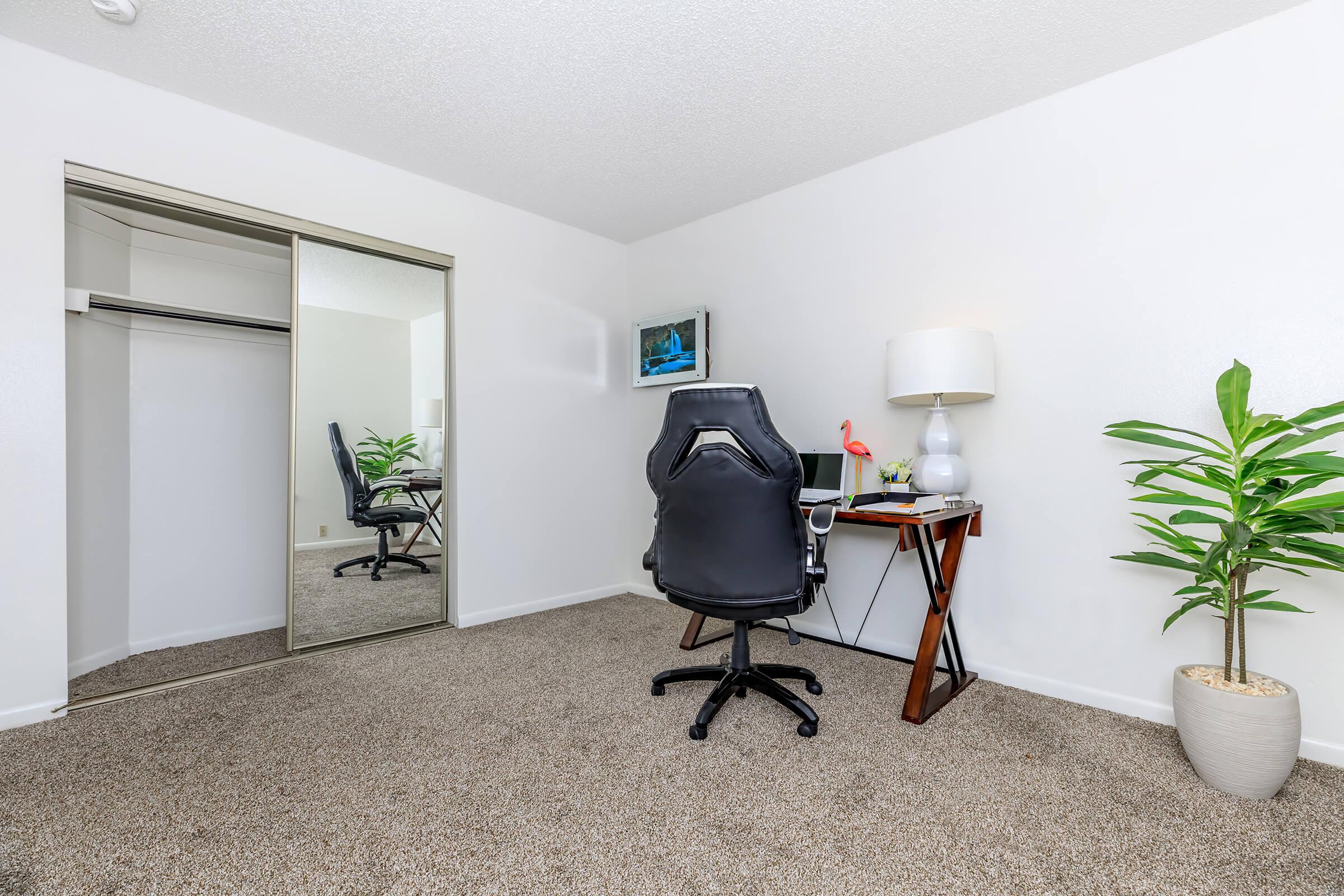 carpeted bedroom with sliding mirror glass closet doors