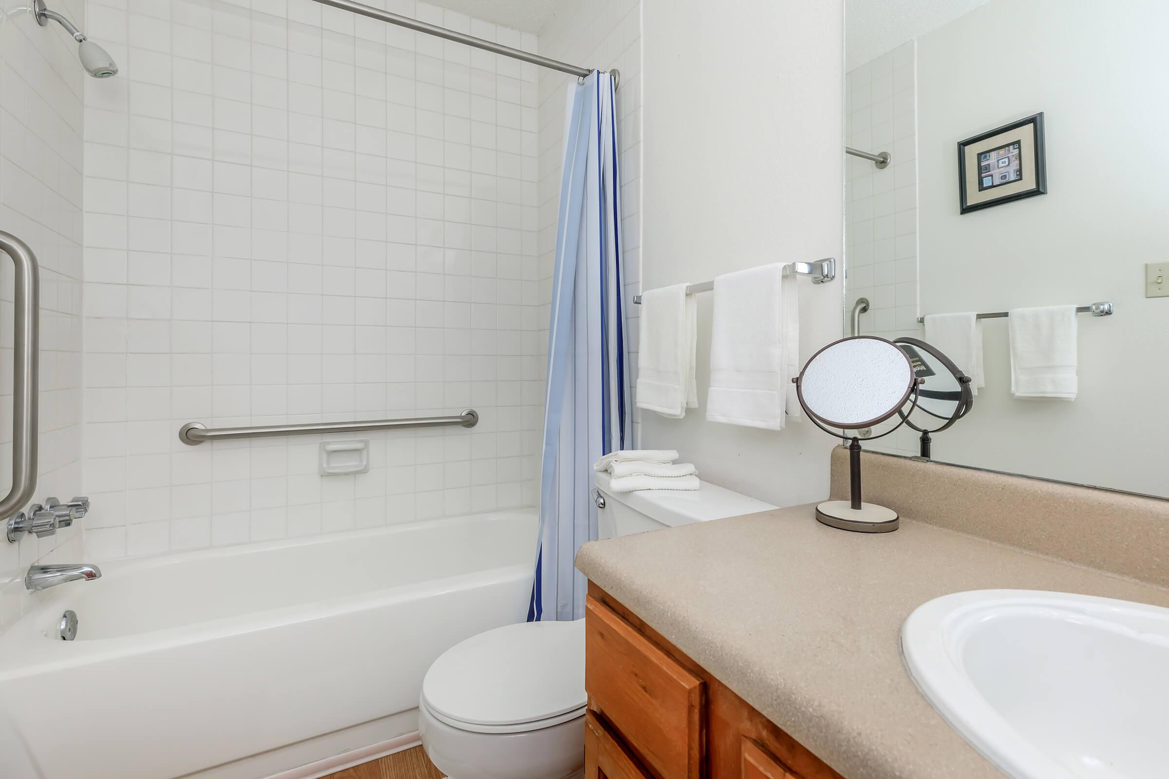 bathroom with a blue shower curtain