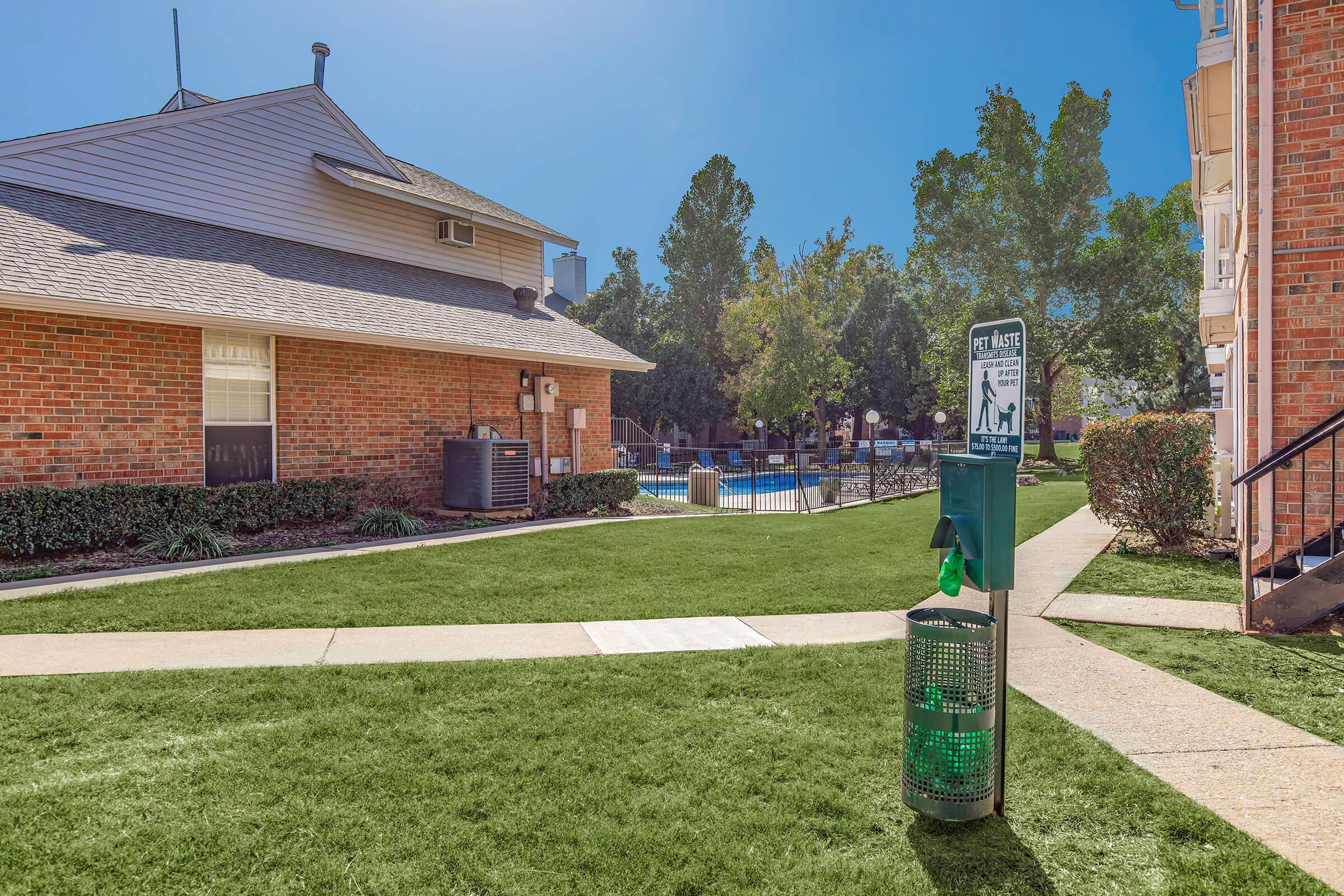 a large lawn in front of a brick building