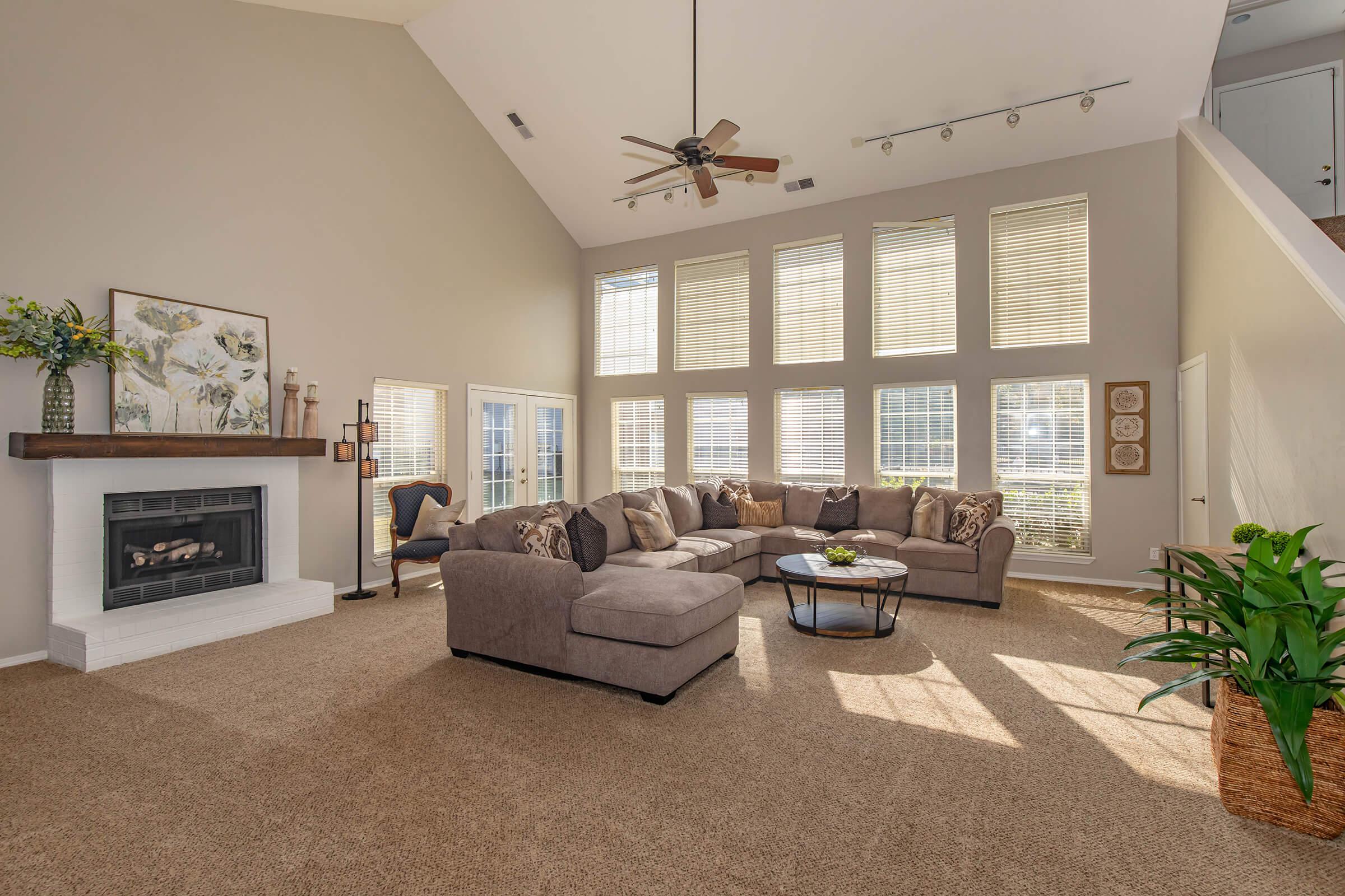 a living room filled with furniture and a large window