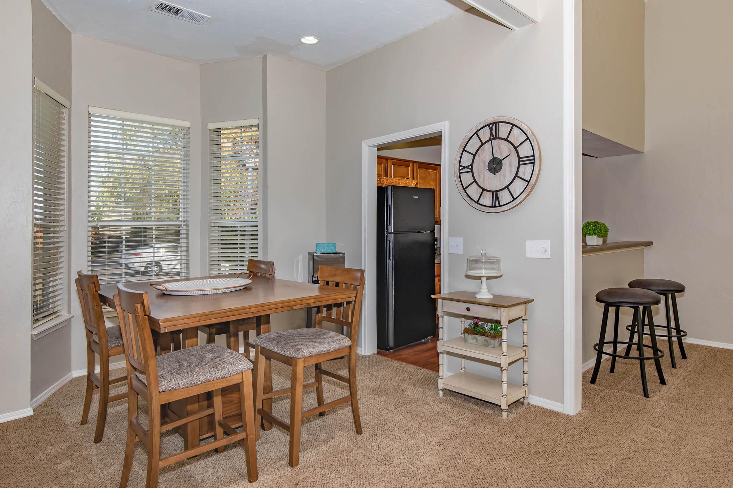 a dining room table in front of a window