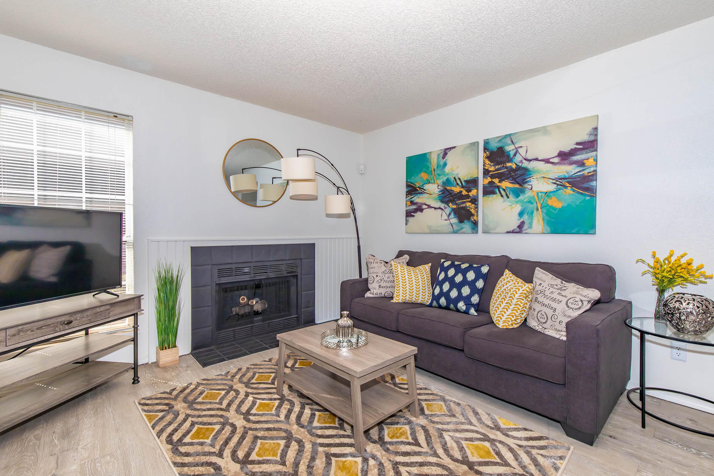 a living room filled with furniture and a fireplace