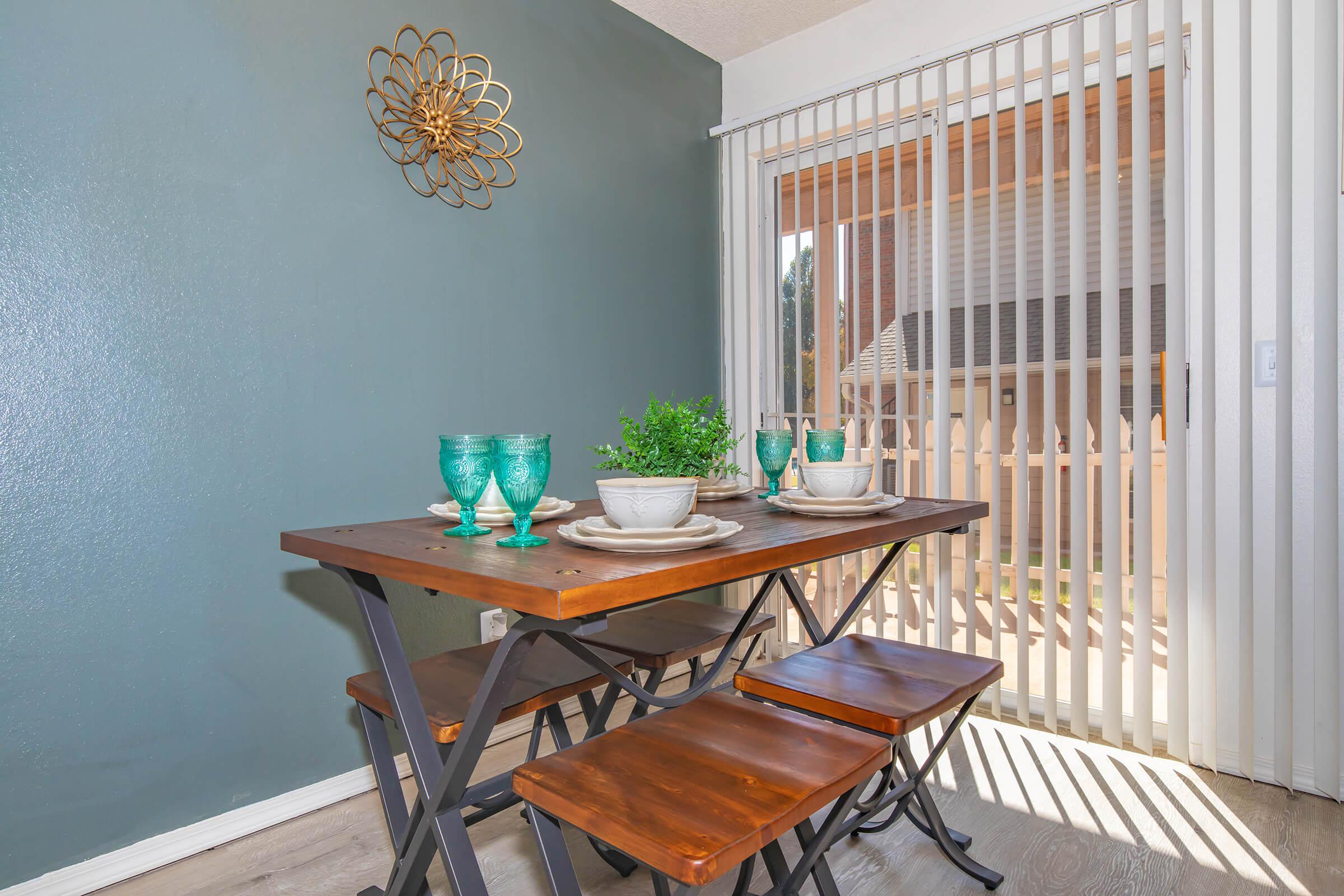 a dining room table in front of a window