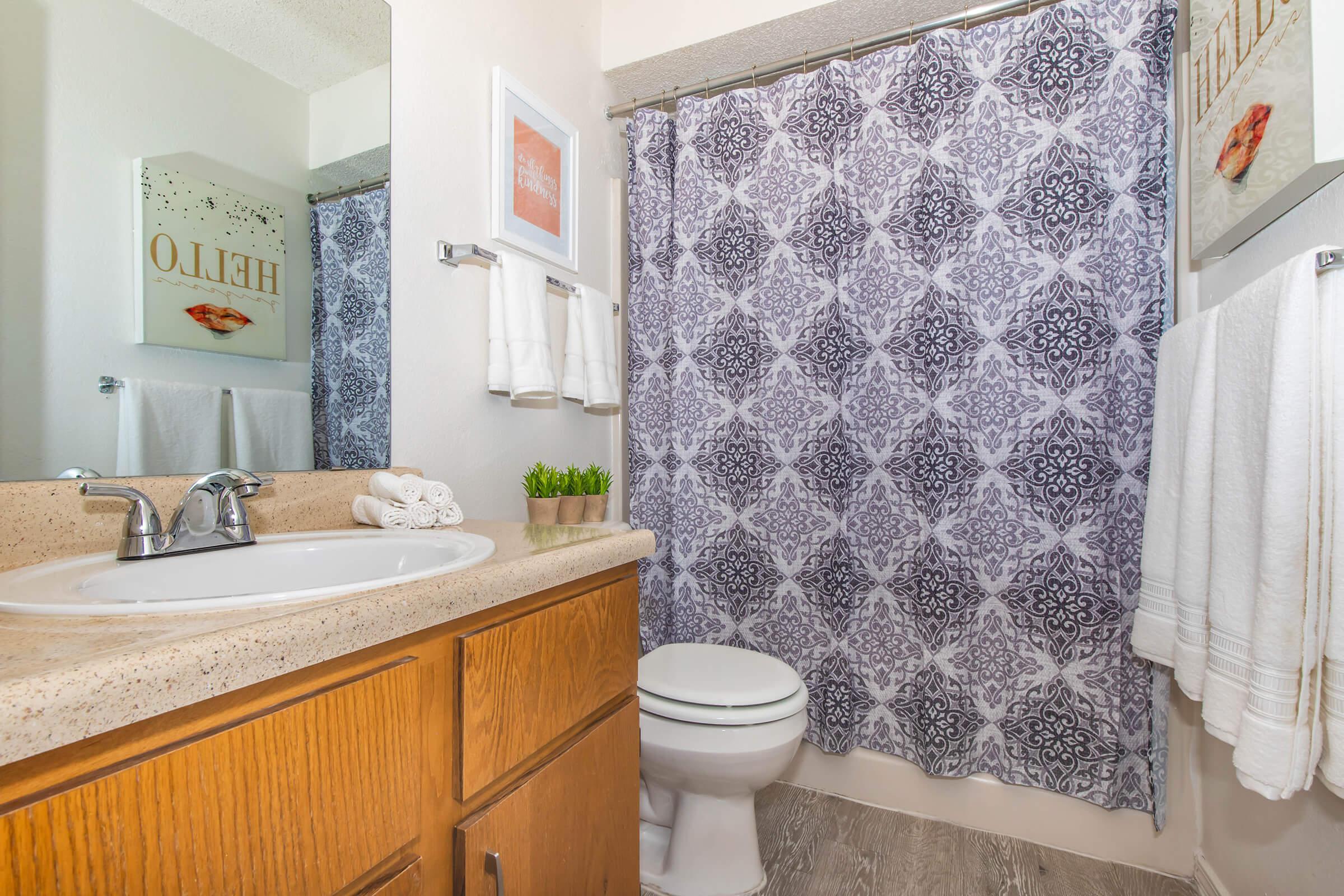 a white sink sitting next to a shower